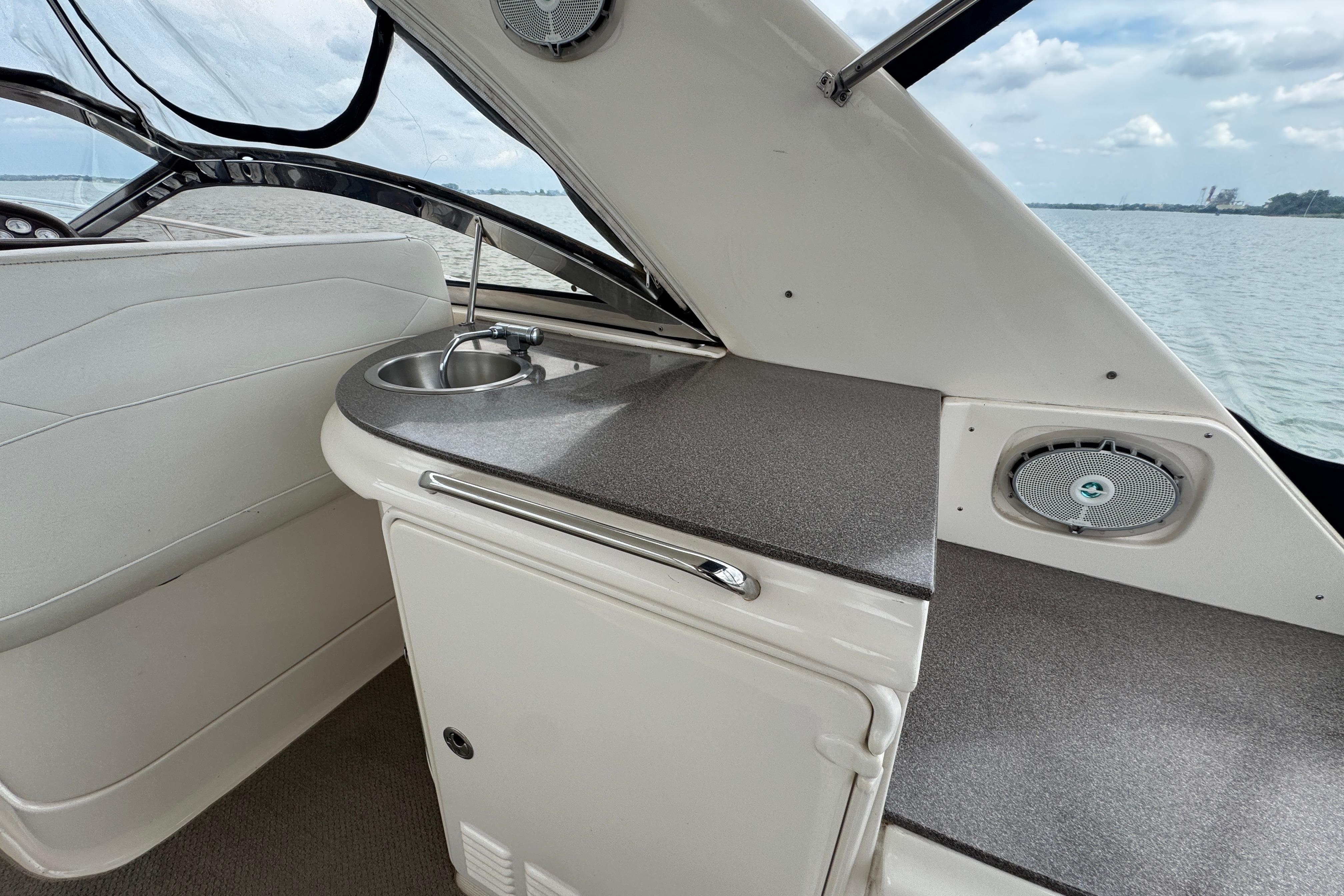 2005 Regal Commodore 4260 yacht interior with sink and countertop, overlooking the ocean.