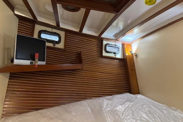 1986 Krogen 42 Classic cabin interior with wood paneling and portholes.