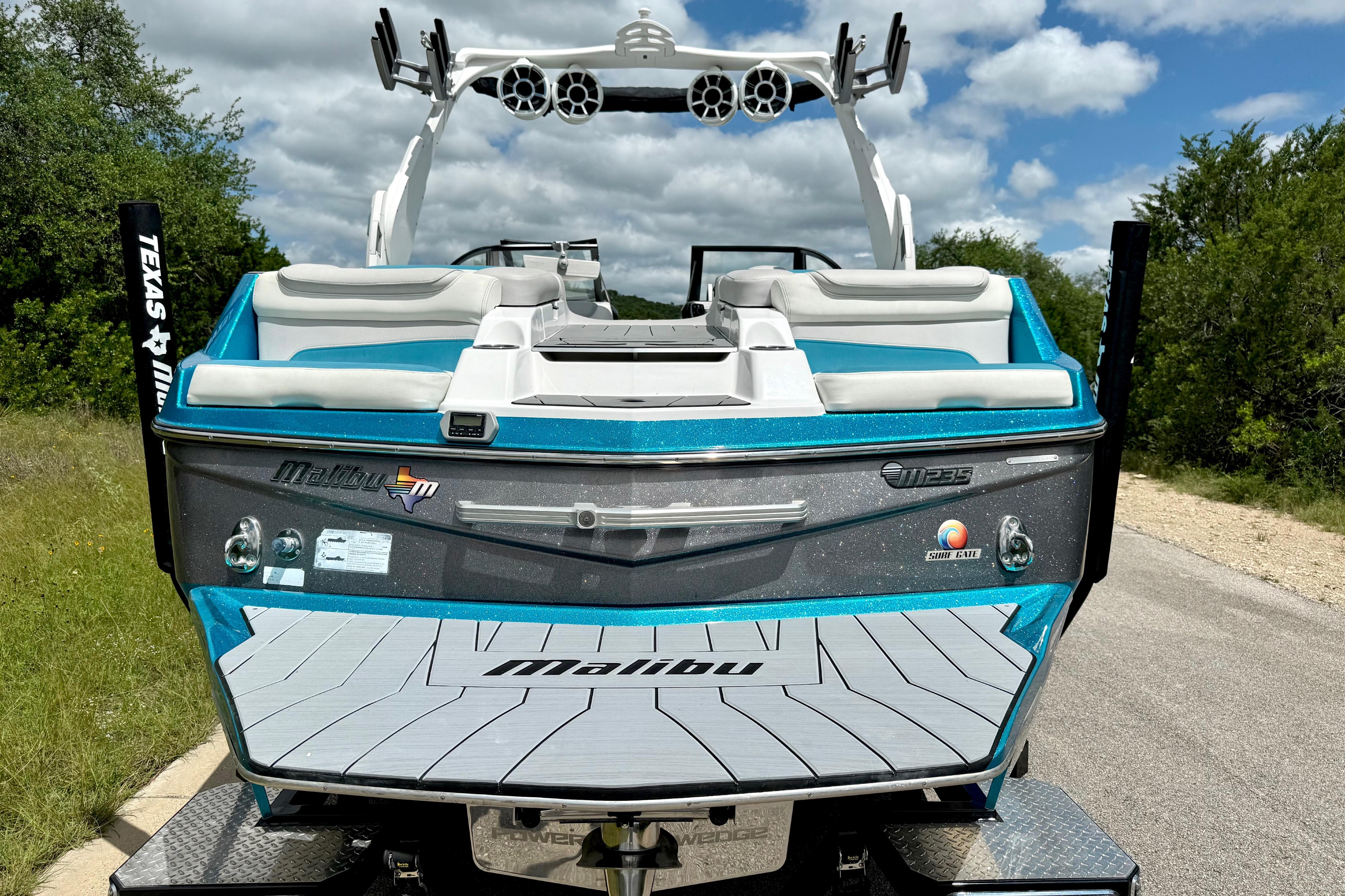 2017 Malibu M235 boat with sleek design, vibrant blue accents, and comfortable seating.