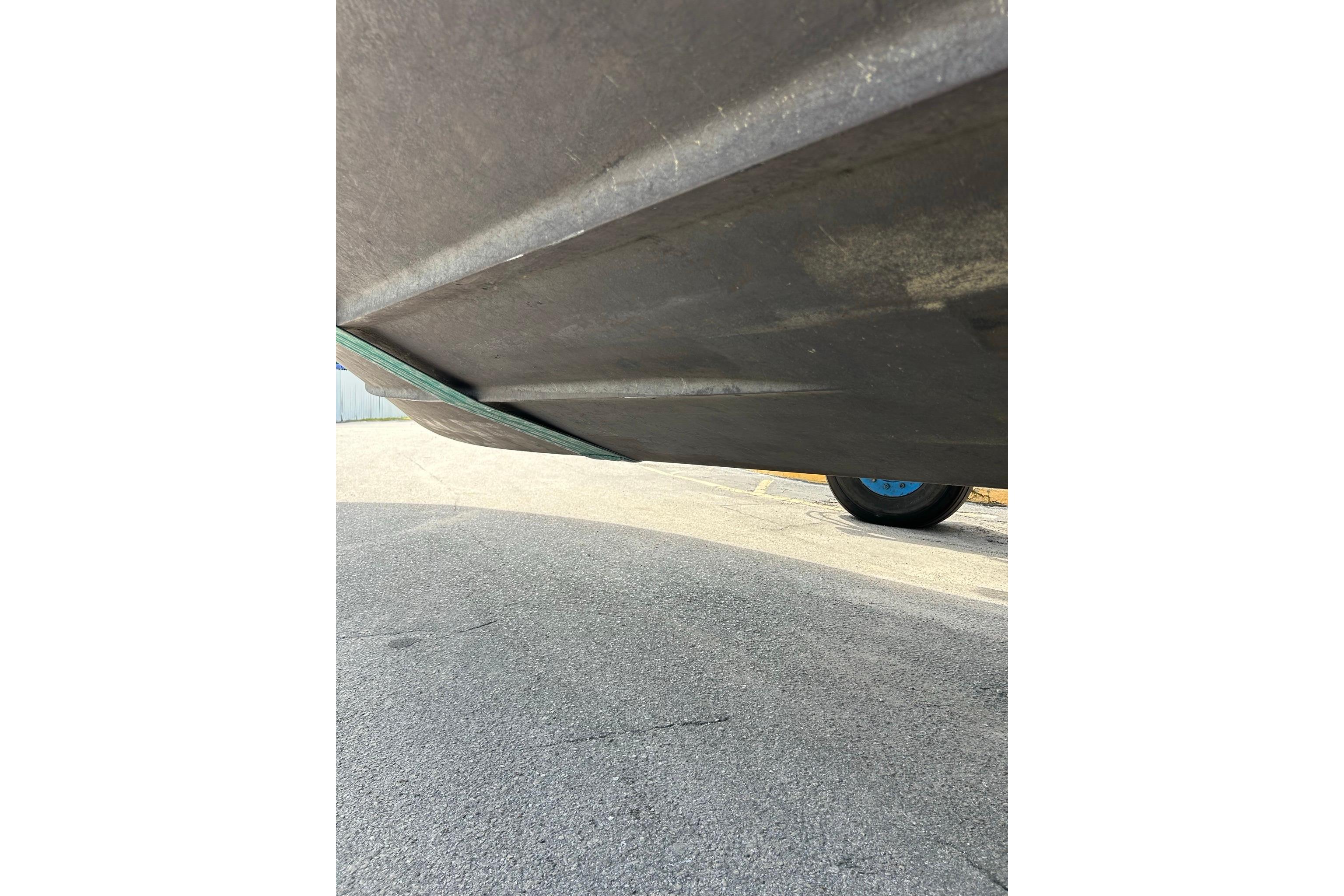 Underside view of a 2019 Monterey 335 Sport Yacht on pavement.