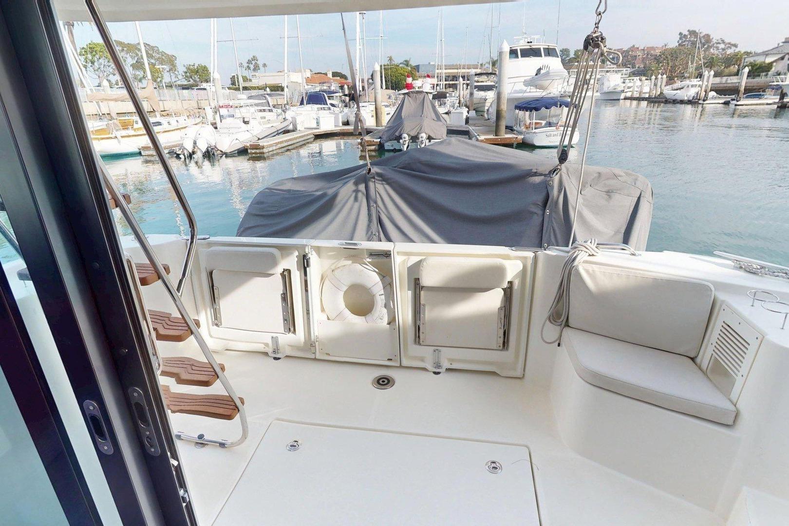 2021 Beneteau Swift Trawler 35, rear deck view in marina setting.