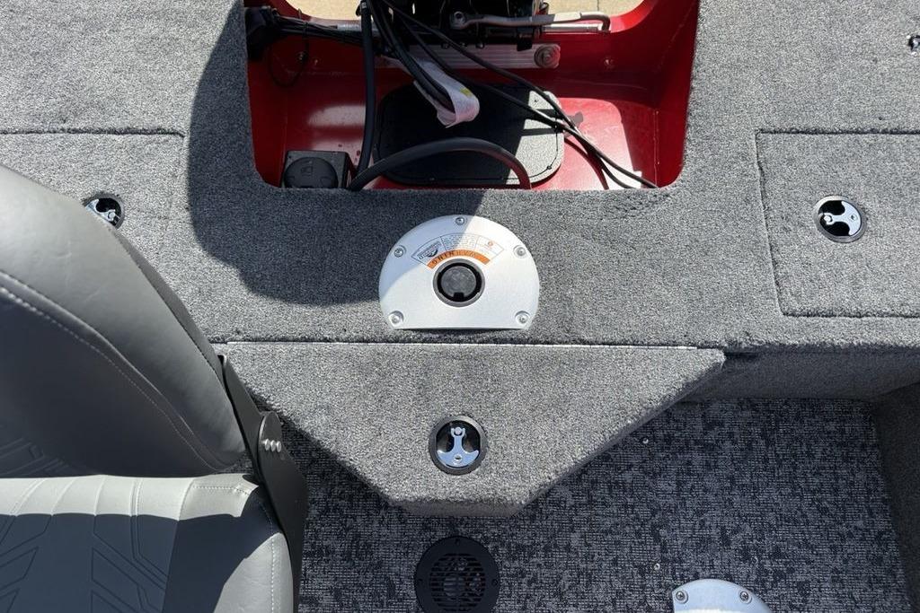 Interior view of 2026 Tracker Pro Guide V-16 SC boat, featuring carpeted flooring and seat.