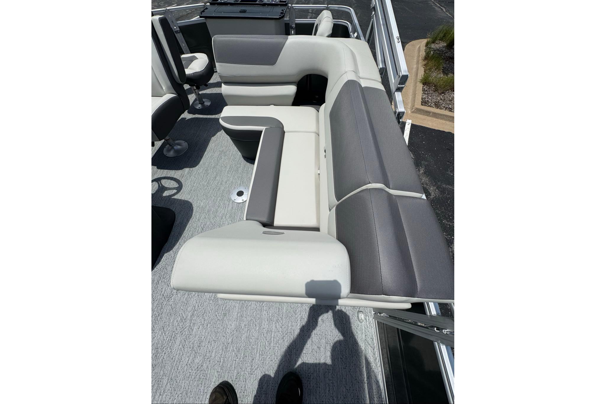2026 Sun Tracker Fishin' Barge 20 DLX interior seating, featuring gray and white upholstery.