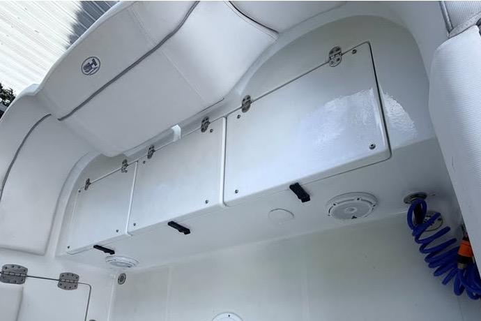 2023 Sea Hunt Ultra 239 SE boat storage compartments and seating area.