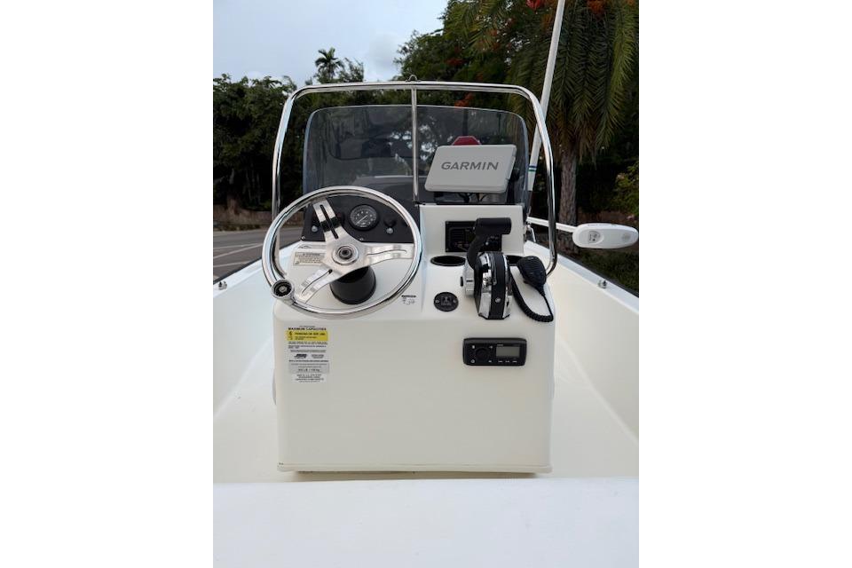 2016 Boston Whaler 150 Montauk boat console with Garmin navigation system and steering wheel.