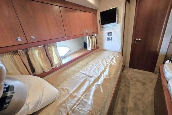 Luxurious cabin interior of 2005 Sunseeker Manhattan 66 yacht with cozy bedding.