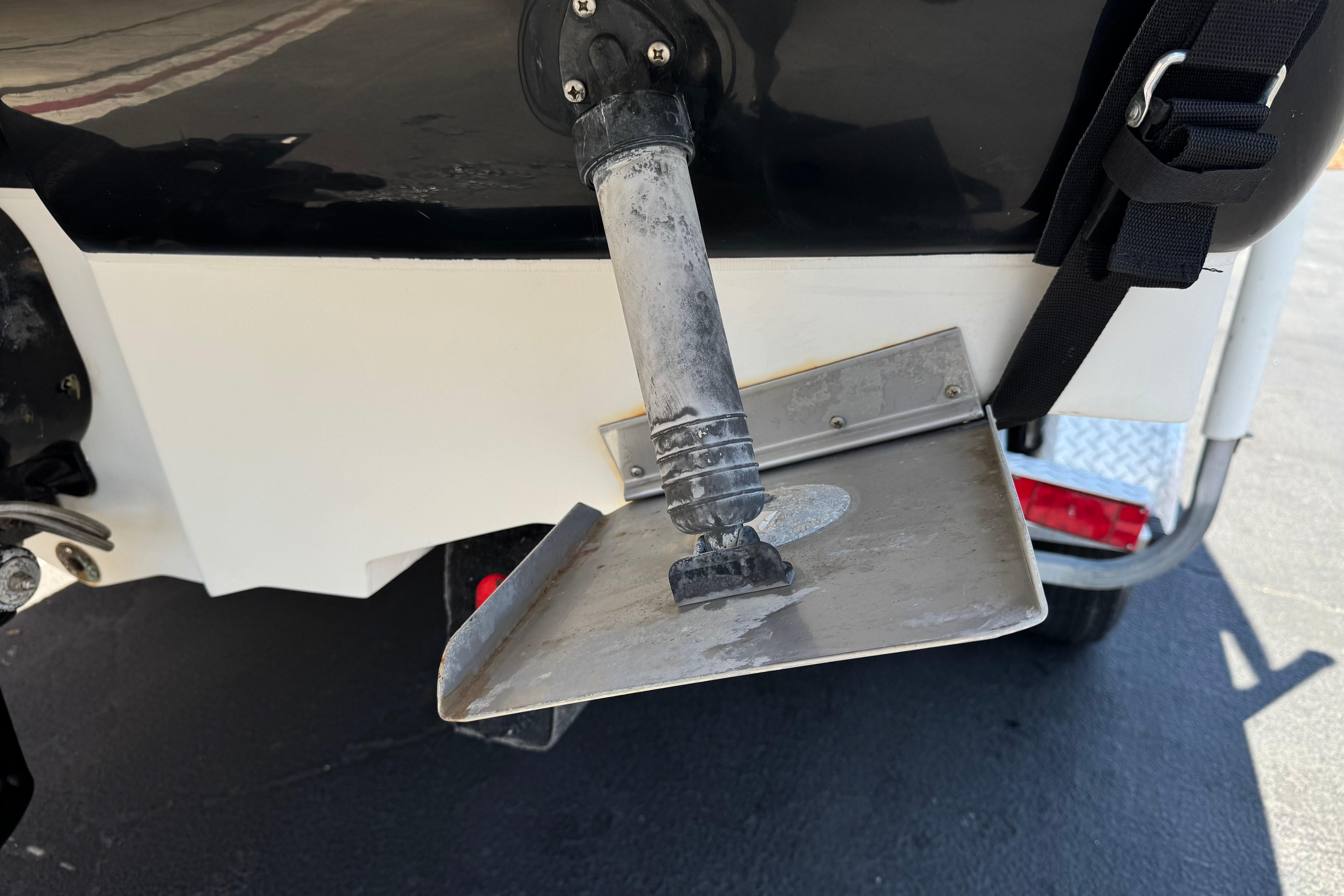 Close-up of a 2007 Sea Ray 240 Sundeck boat's trim tab and outdrive.