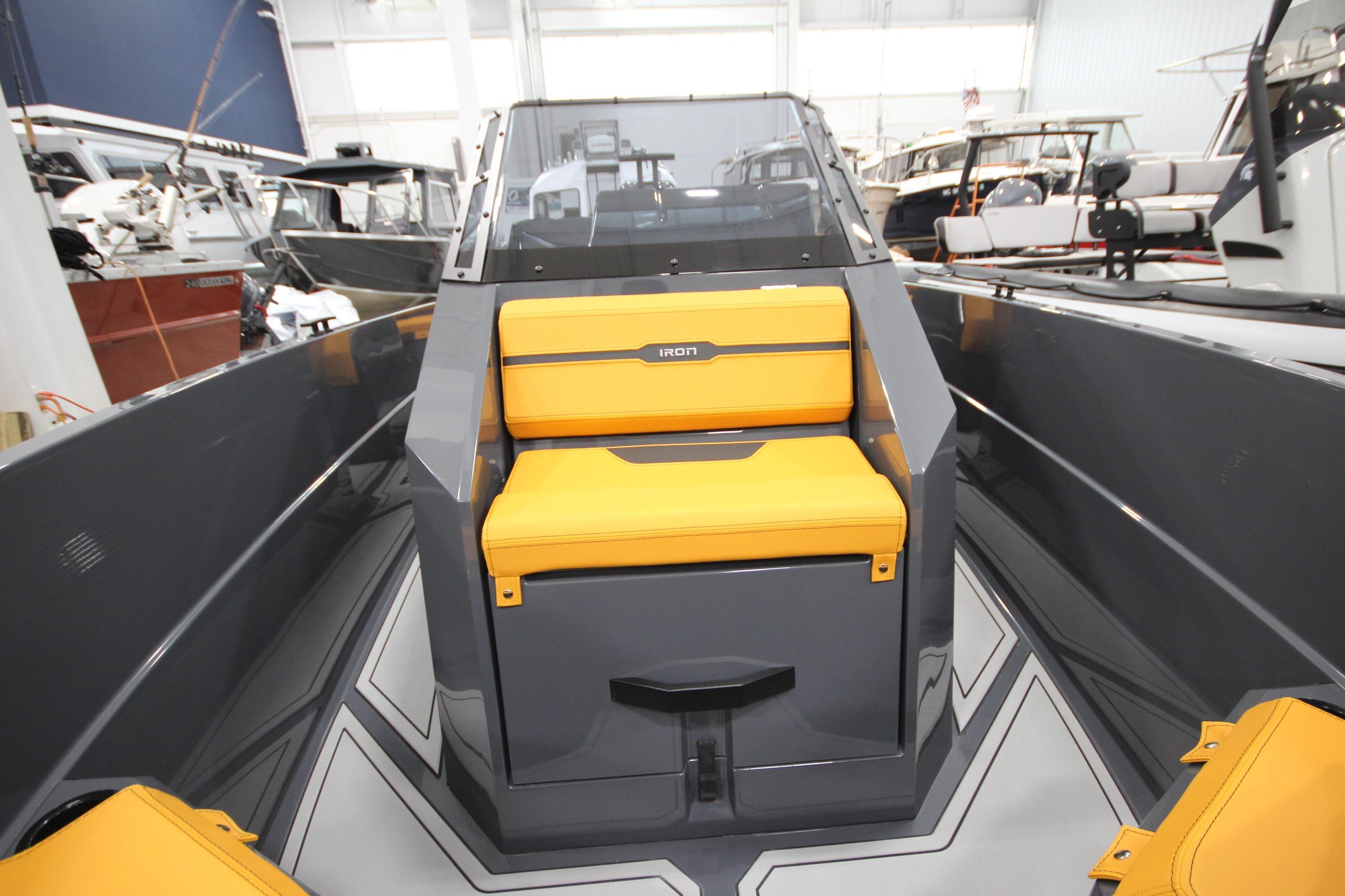2026 IRON BOATS IRON 767 with yellow seating, showcased in a boat showroom.