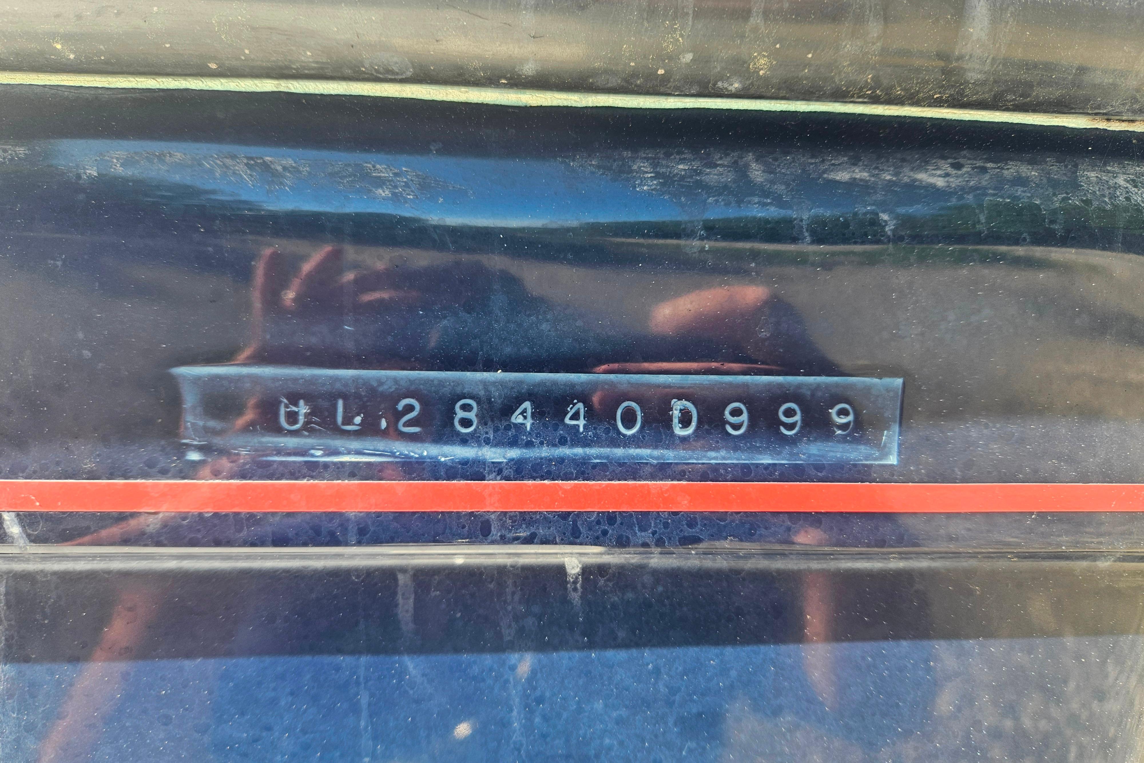 1999 Albin 28 Tournament Express hull identification number with red stripe detail.