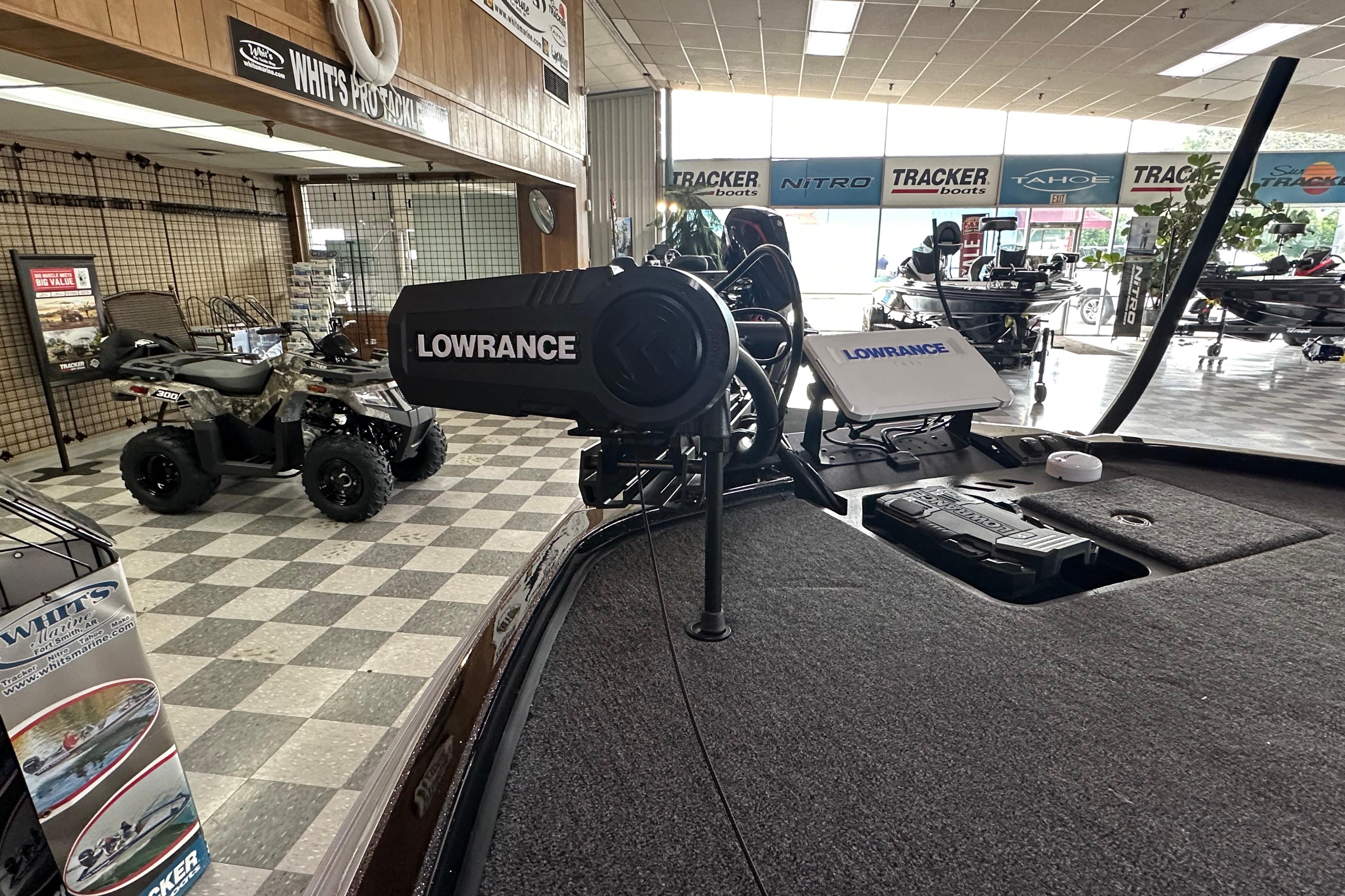 2024 Triton 20XP Patriot boat with Lowrance equipment in a showroom.