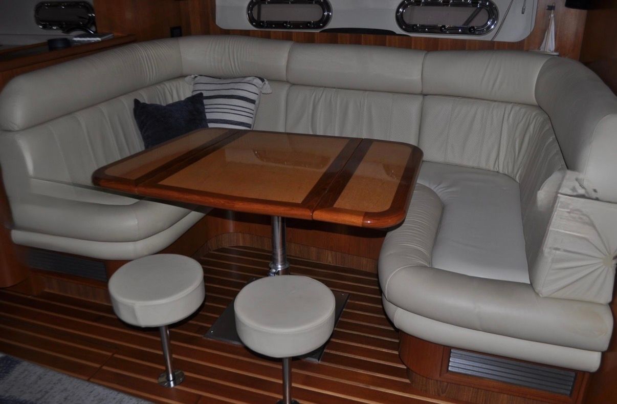 Interior of a 2005 Tiara Yachts 5200 Sovran with an elegant seating area and wooden table.