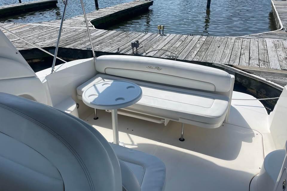 2003 Sea Ray 300 Sundancer boat interior with seating and table at dock.