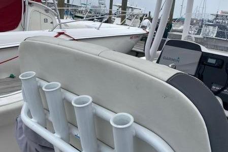 2020 Tidewater 220 CC boat with rod holders and Garmin equipment at a marina.