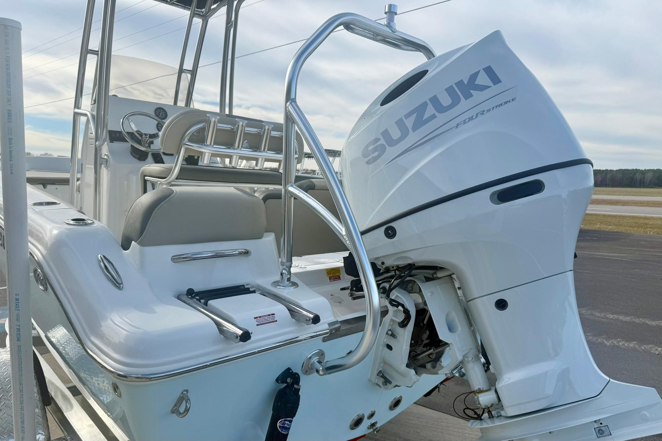 2026 Key West 189 FS boat with Suzuki outboard motor, docked on a sunny day.