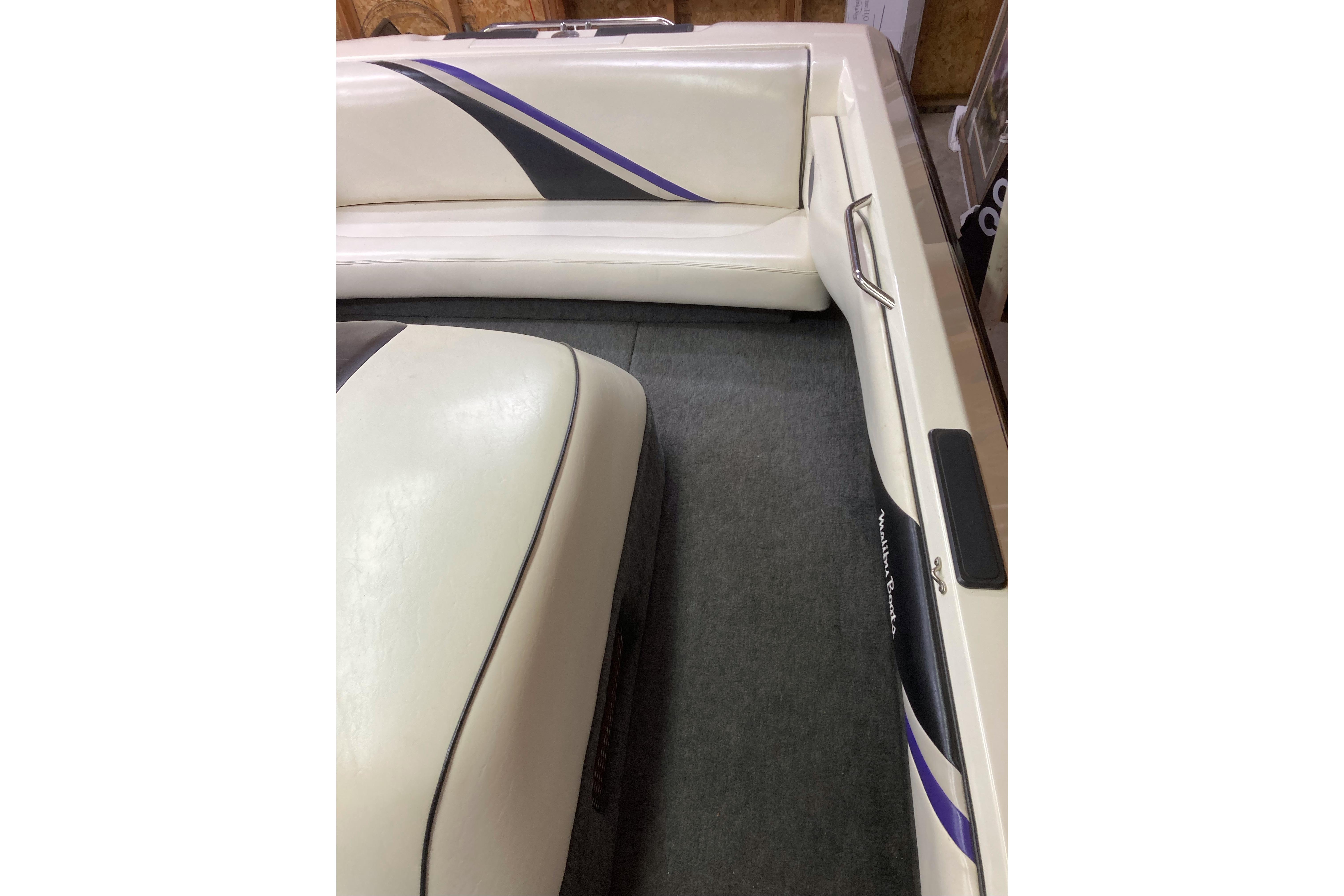 1996 Malibu Response boat interior with white upholstery and black accents.