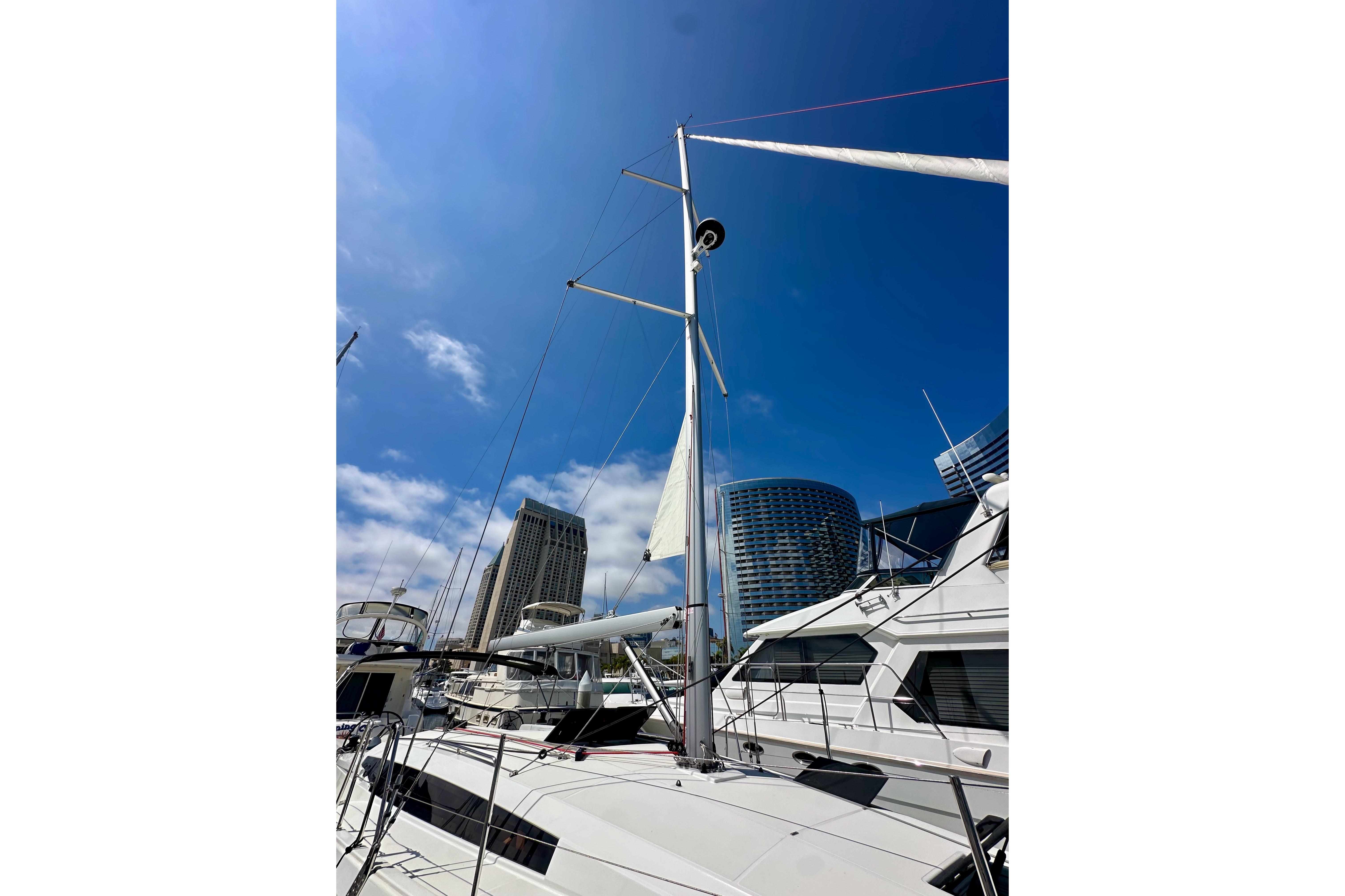2024 Jeanneau Sun Odyssey 410 sailboat docked with city skyline background.