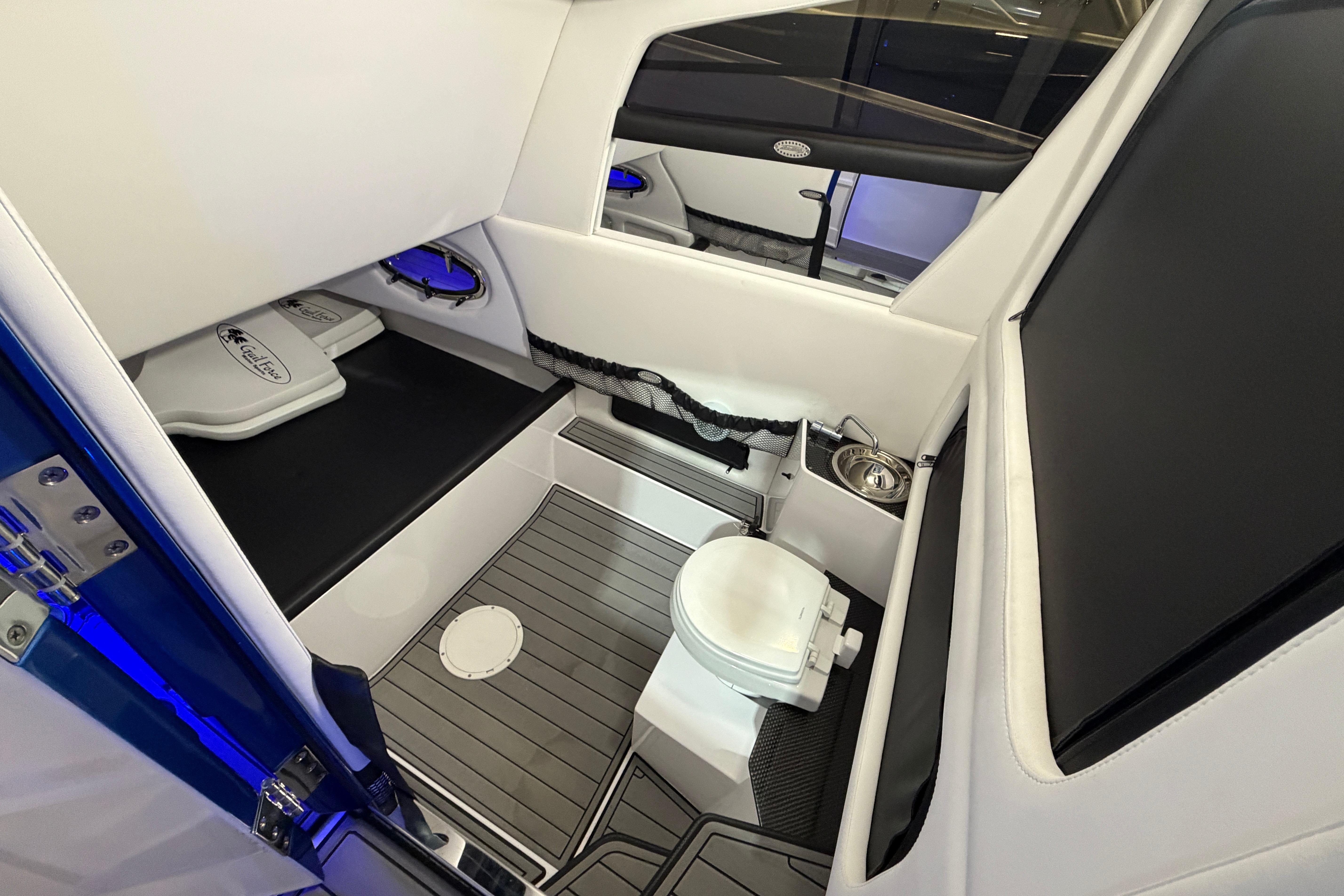 Interior of 2020 Nor-Tech 340 Sport Center Console with toilet and seating area.