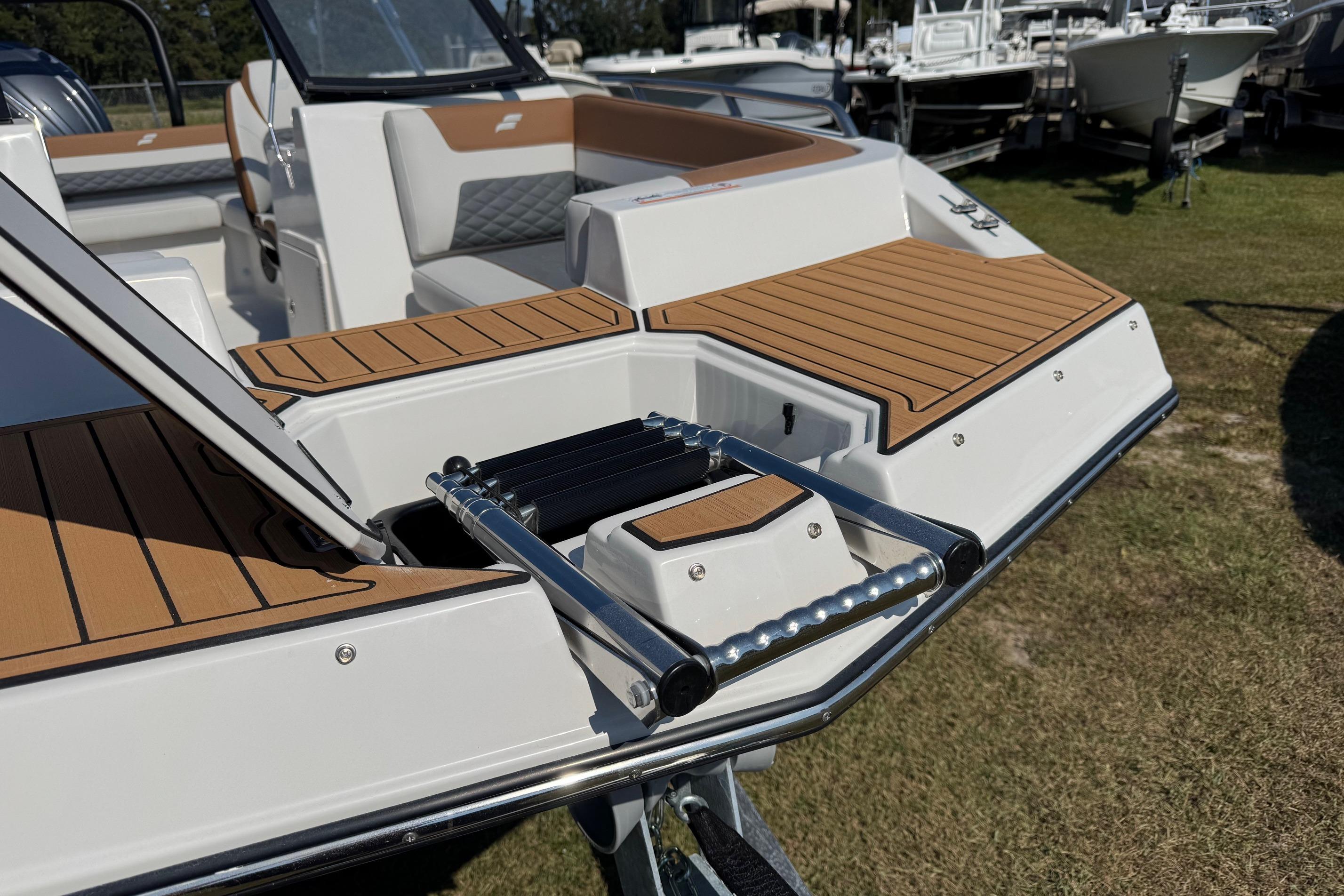 2026 Starcraft SVX 190 OB boat with teak deck and swim ladder.