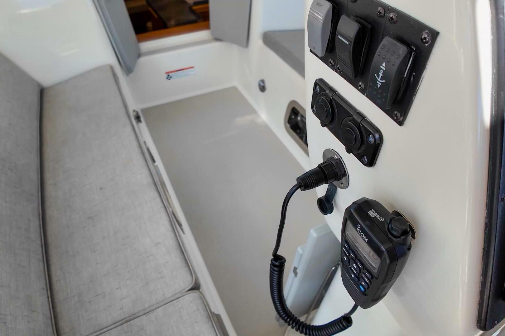 Interior view of 2023 Island Packet 439 sailboat with control panel and seating area.