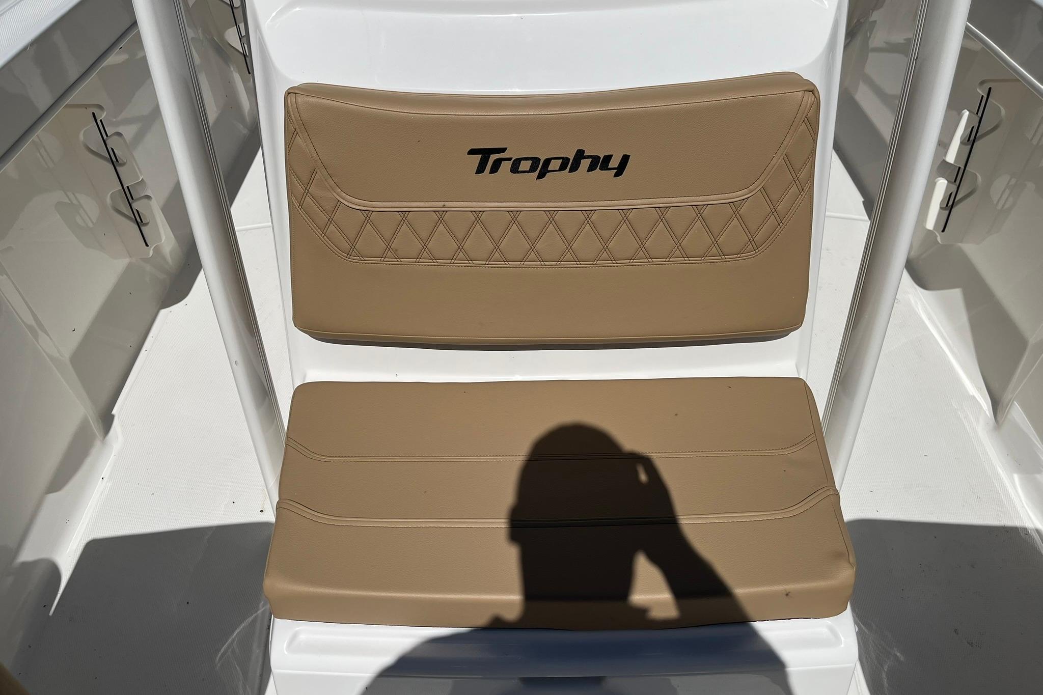 2026 Bayliner Trophy T22CC boat seat with tan upholstery and "Trophy" logo.