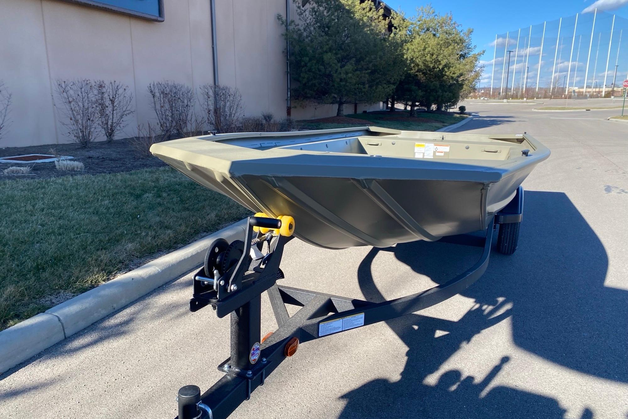 2026 Tracker Grizzly 1754 Utility boat on trailer, parked outdoors on sunny day.