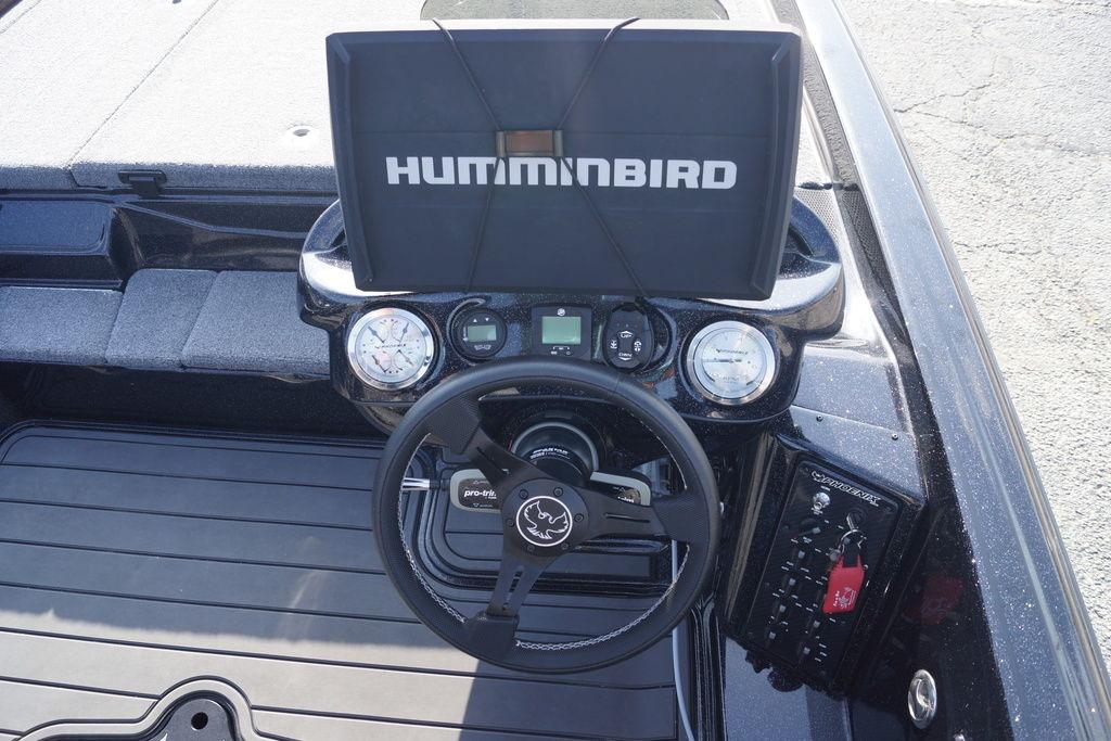 Dashboard of 2025 Phoenix 921 Elite boat with Humminbird display and steering wheel.