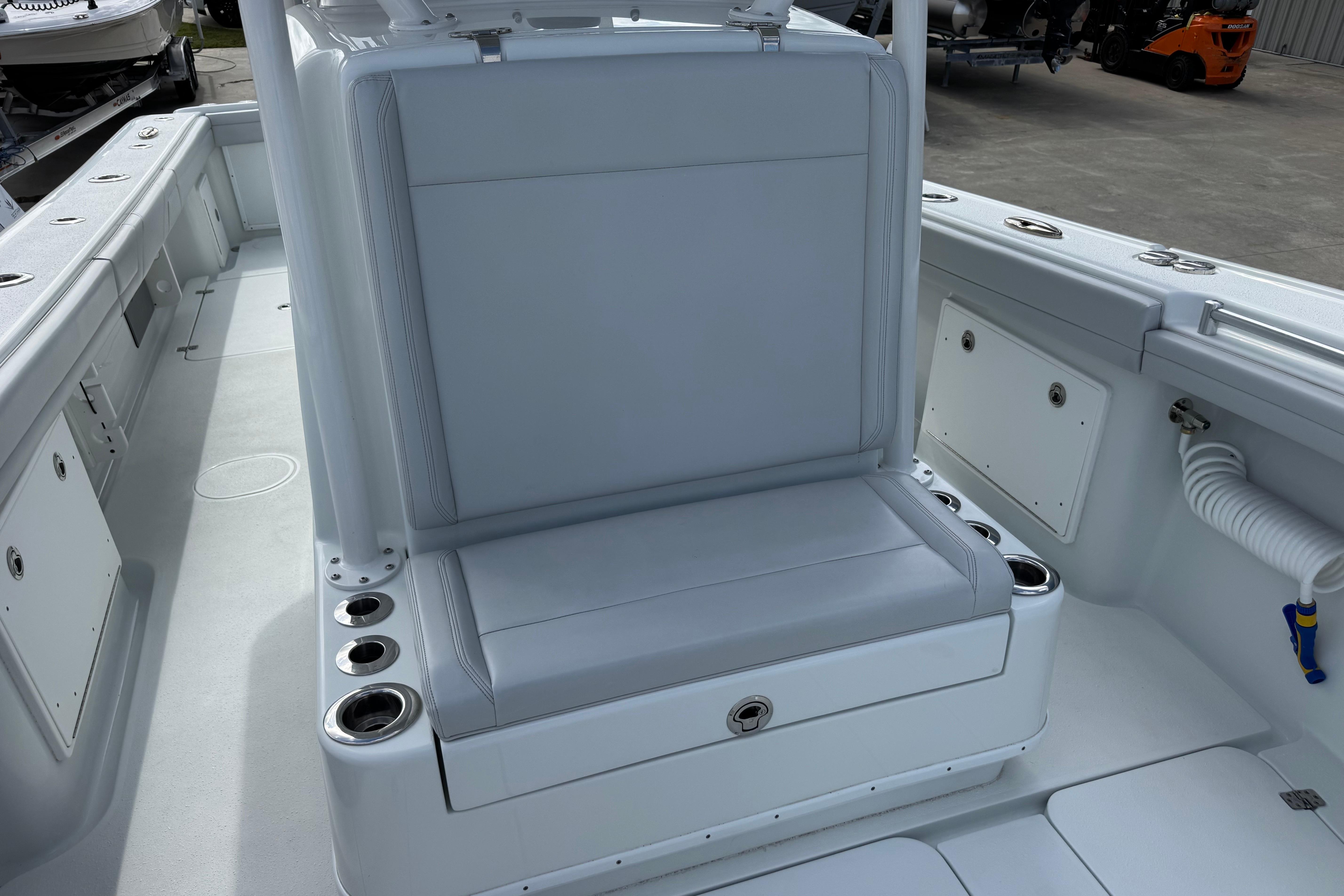 2022 Yellowfin 32 Offshore boat interior with cushioned seating and cup holders.