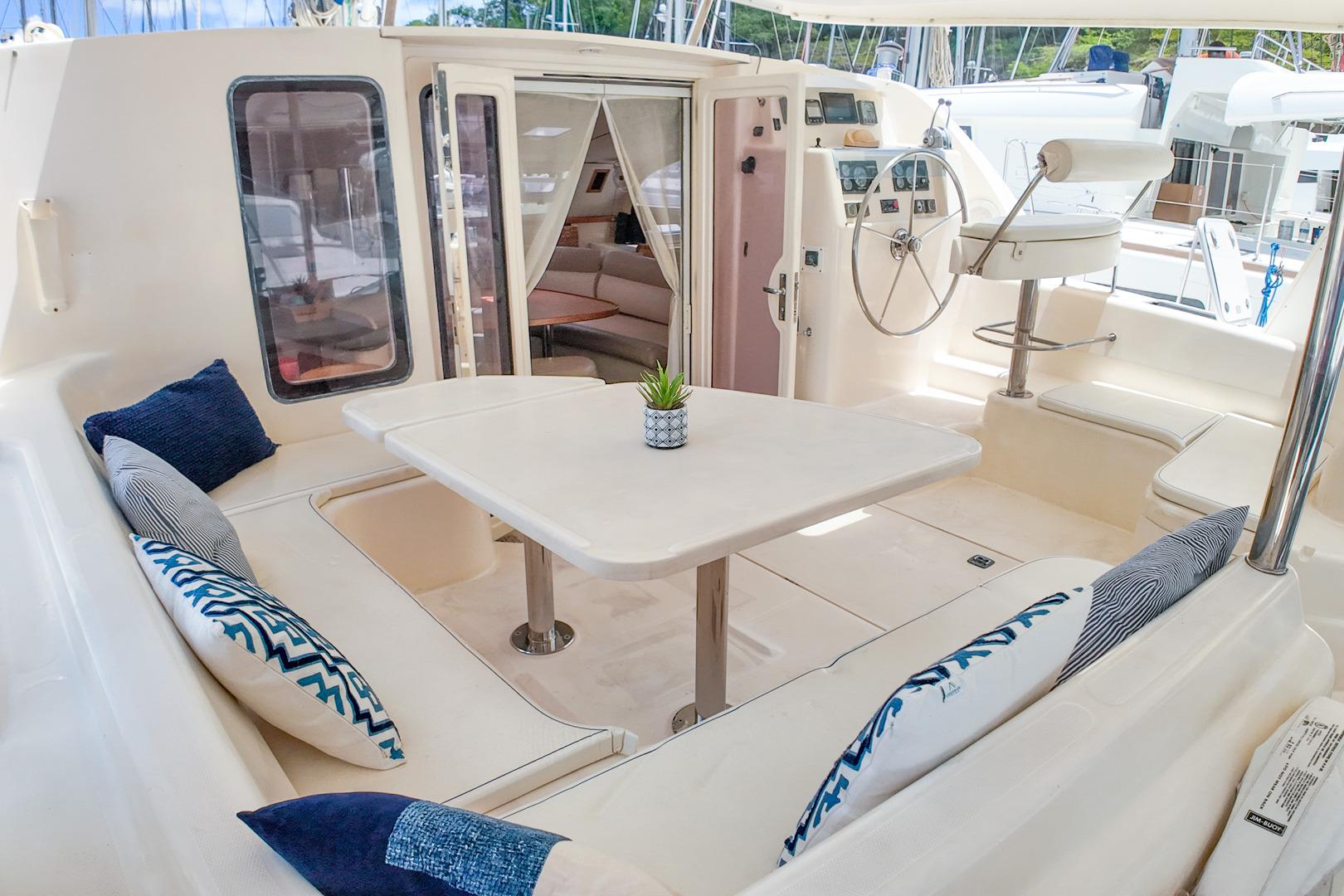 2005 Leopard 43 yacht cockpit with seating, table, and helm station.
