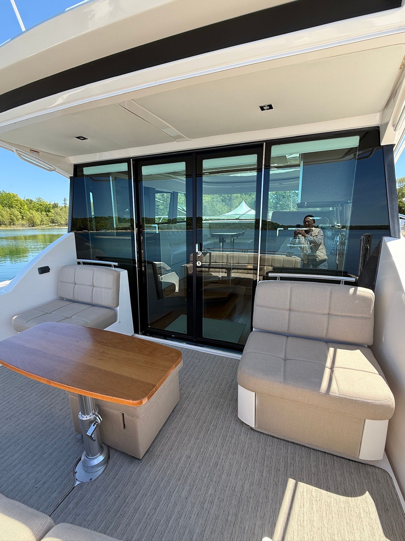 The 2017 Tiara Yachts C44 Coupe features an elegant outdoor seating area with a table and cushioned seats.