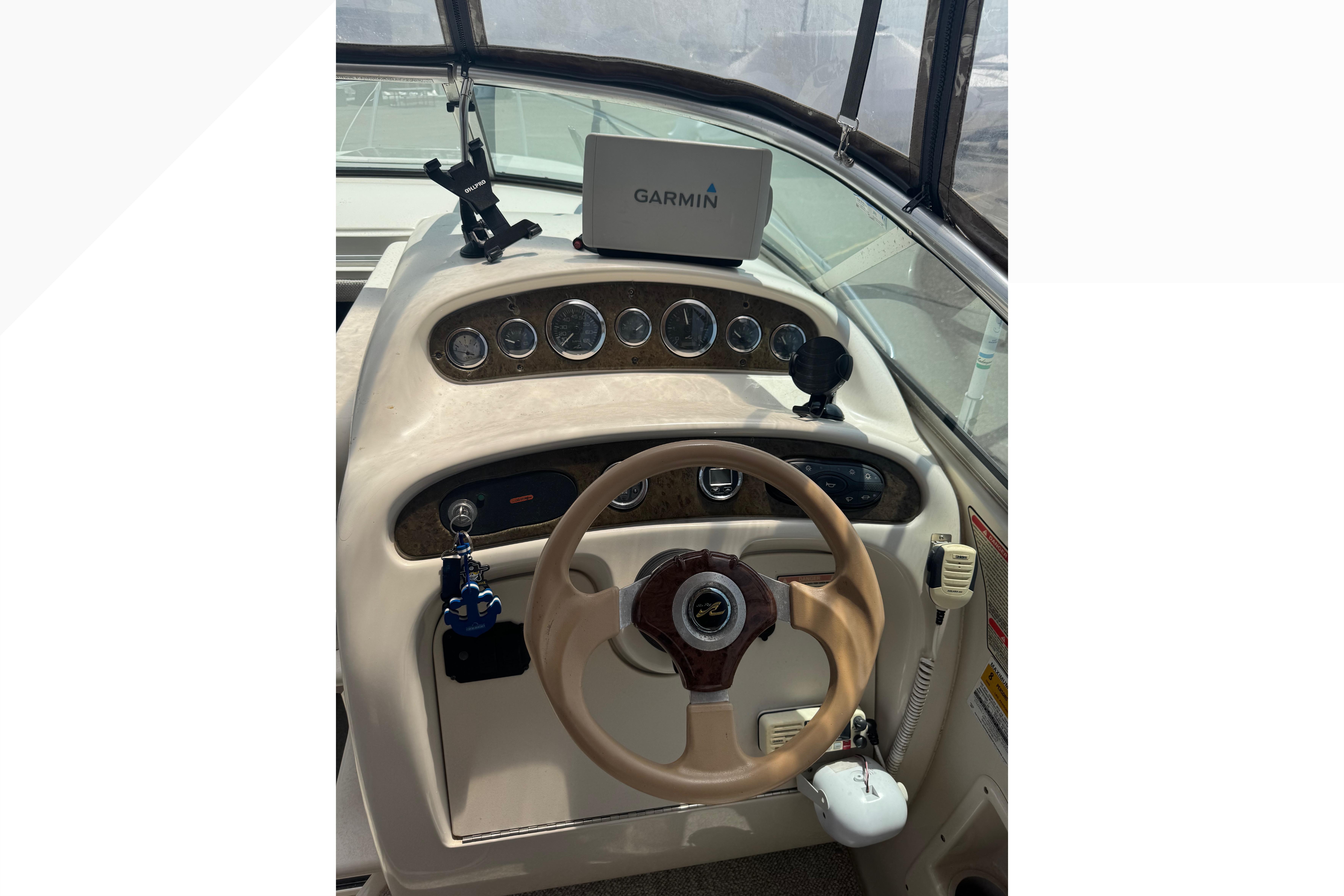 2001 Sea Ray 245 Weekender helm with Garmin GPS and classic steering wheel.