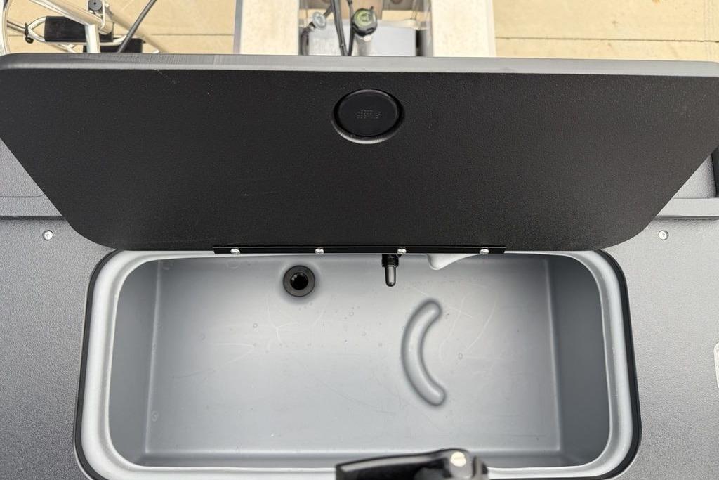 Open storage compartment on 2026 Sun Tracker Fishin' Barge 20 DLX boat.