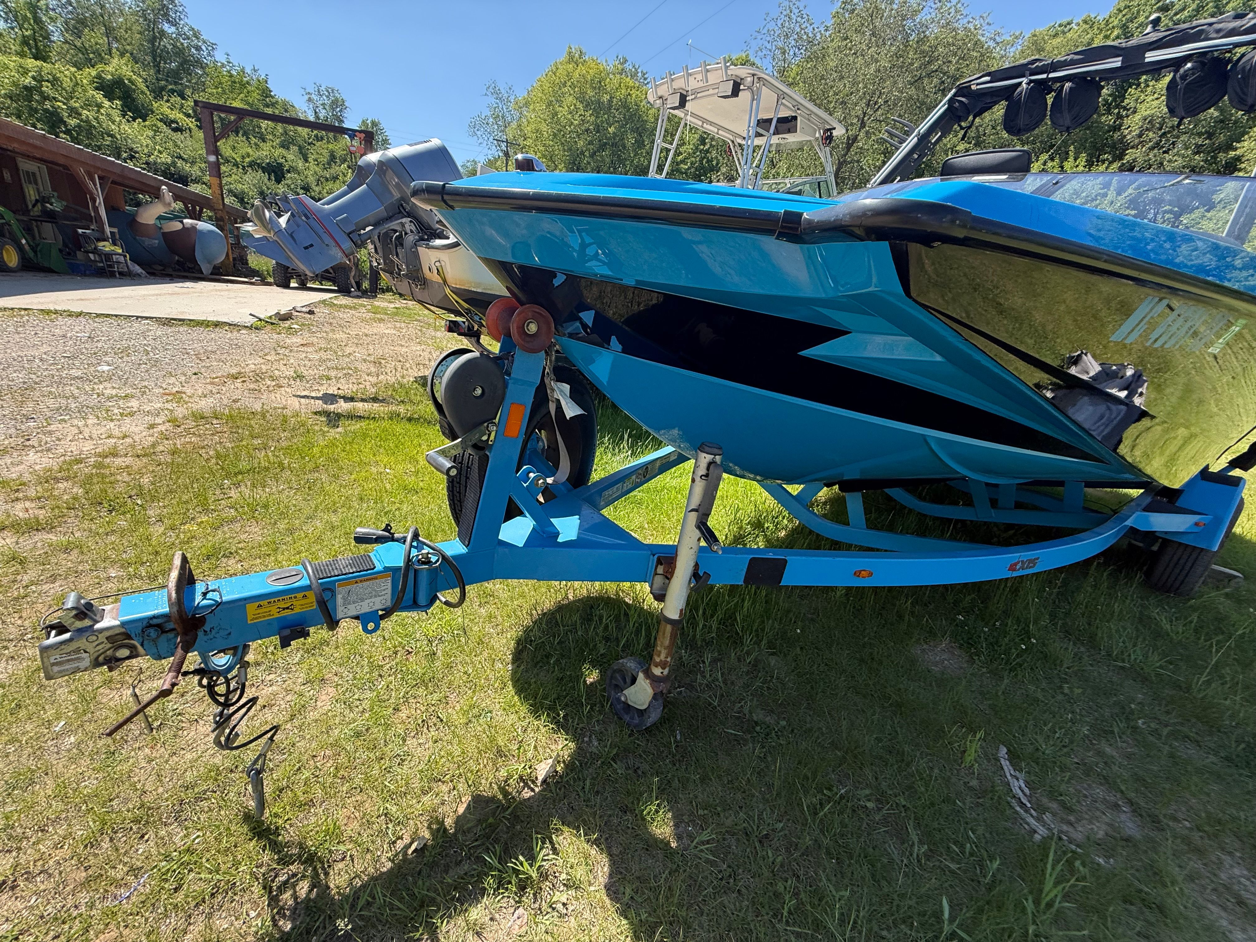 2015 Malibu Axis A20 boat on trailer parked outdoors.