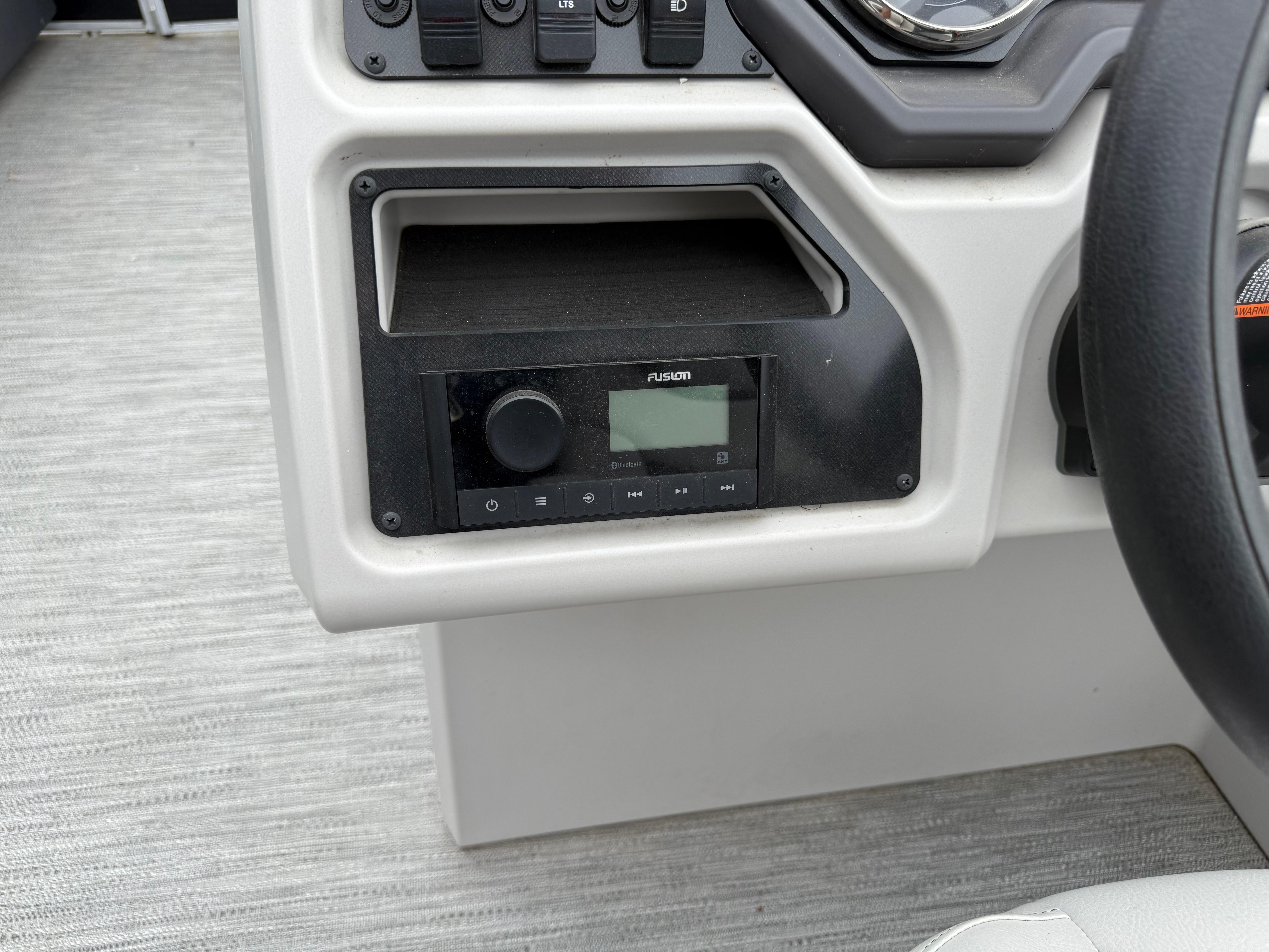 2023 Godfrey Sweetwater boat dashboard with Fusion audio system and control panel.