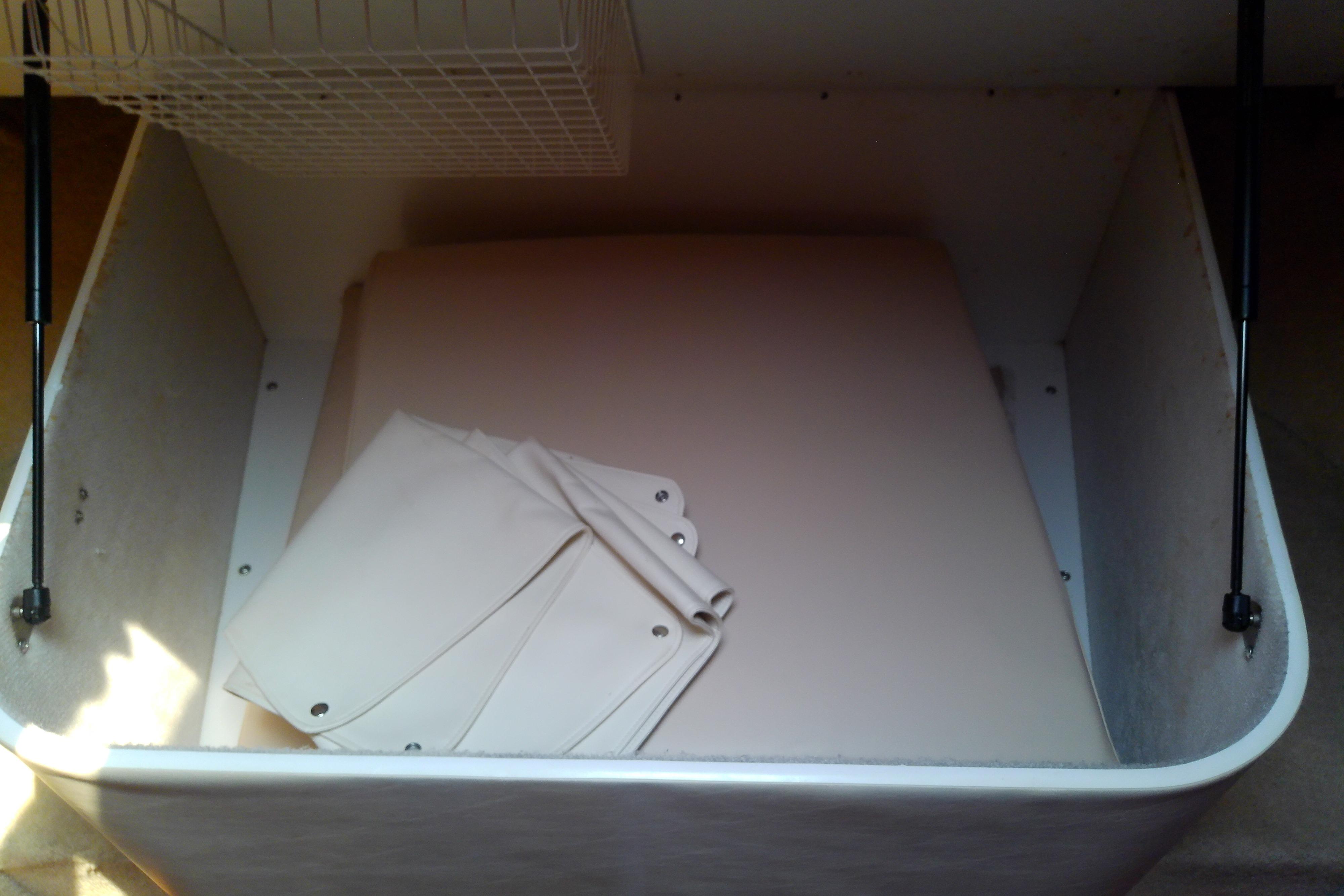 Storage compartment in a 2000 Tiara Yachts 4100 Open, featuring folded canvas covers.