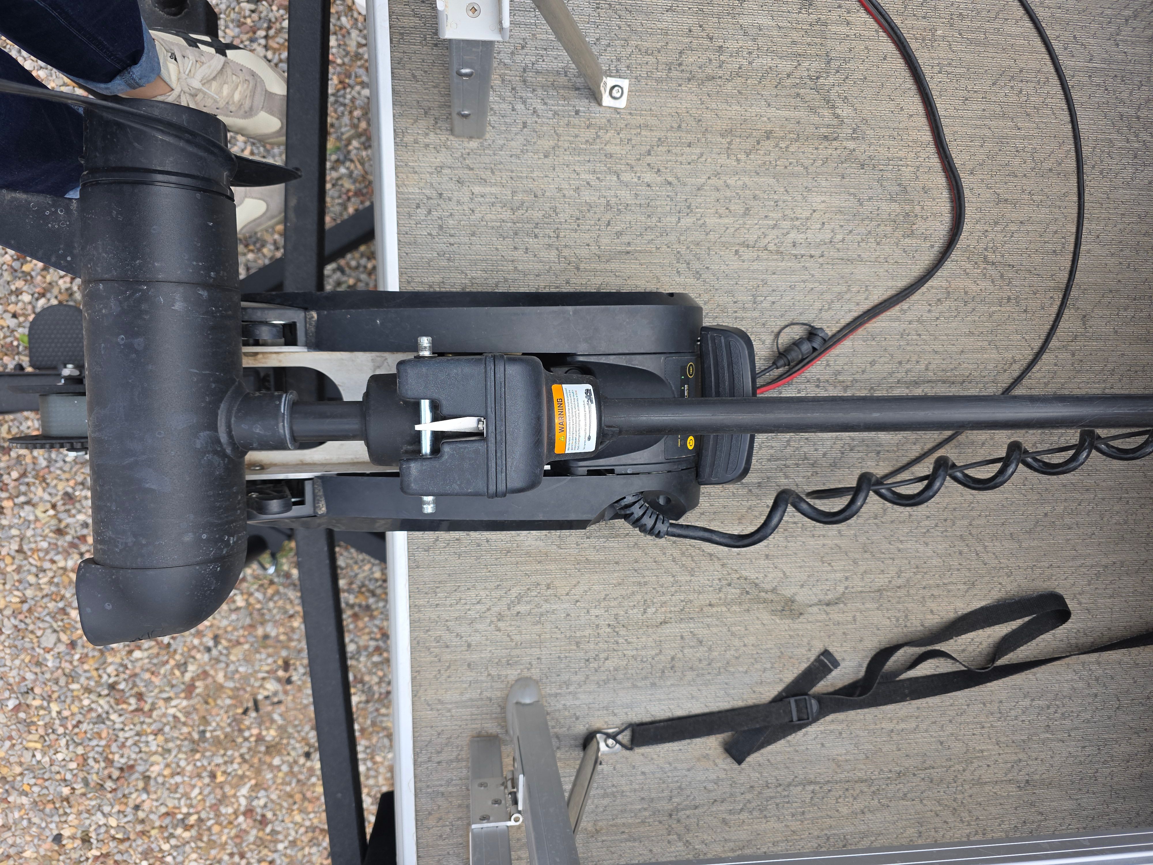 Close-up of a boat deck with a motor and cables.