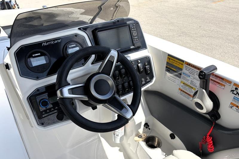 2026 Hurricane SunDeck Sport 2050 OB boat dashboard with steering wheel and controls.