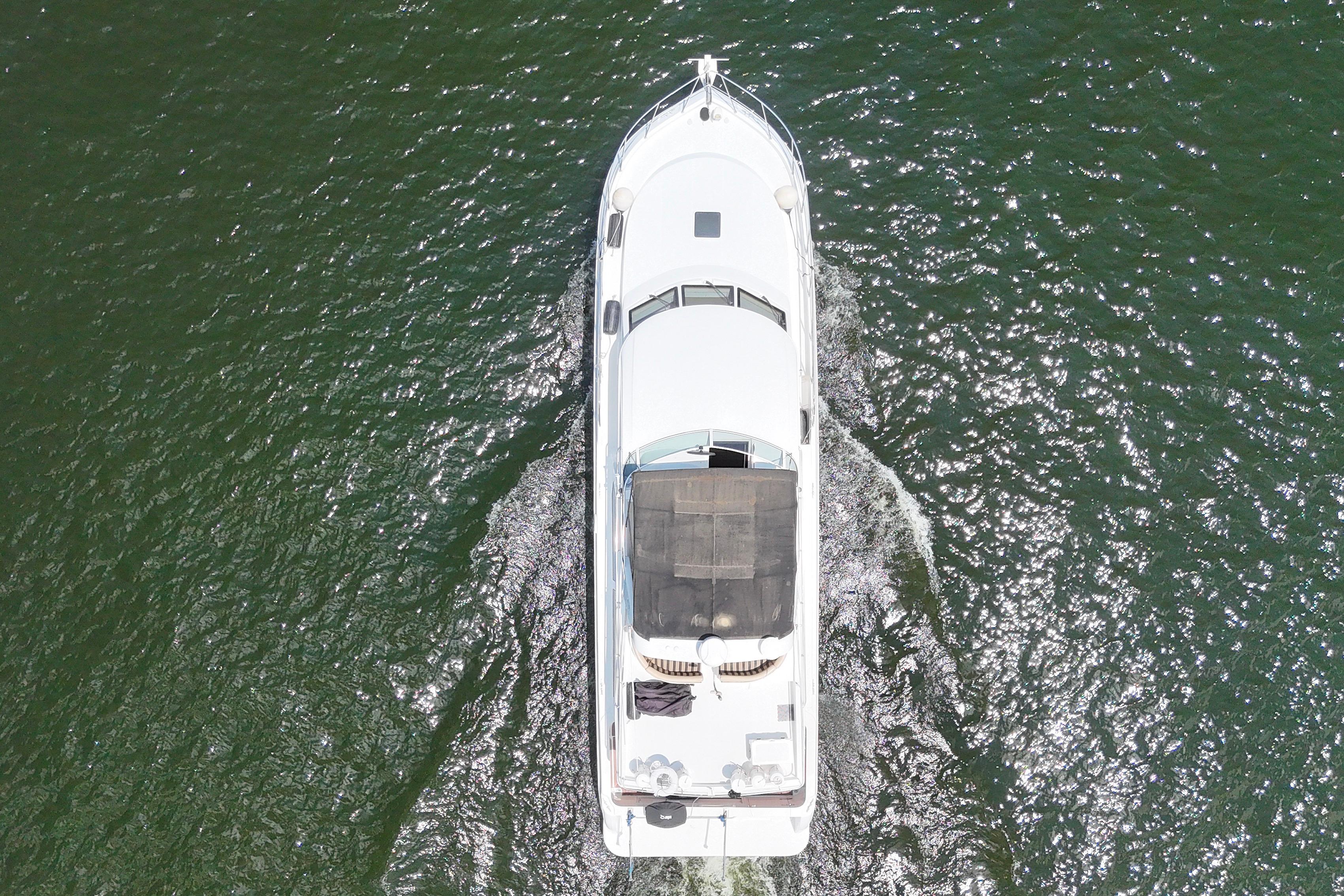 Aerial view of 2007 Navigator 5100 yacht cruising on shimmering water.