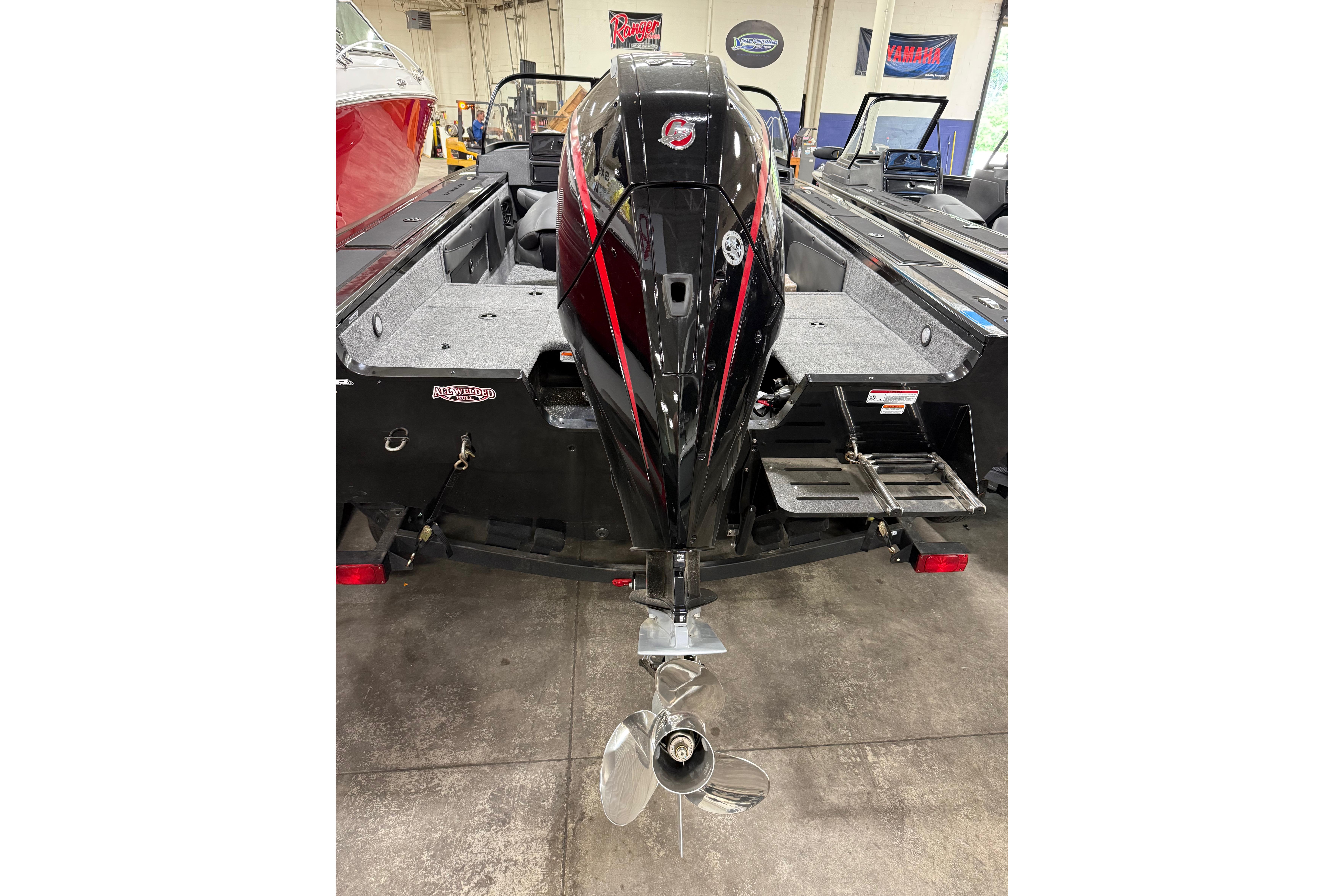 2026 Tracker Targa V-19 WT boat with powerful outboard motor in showroom.