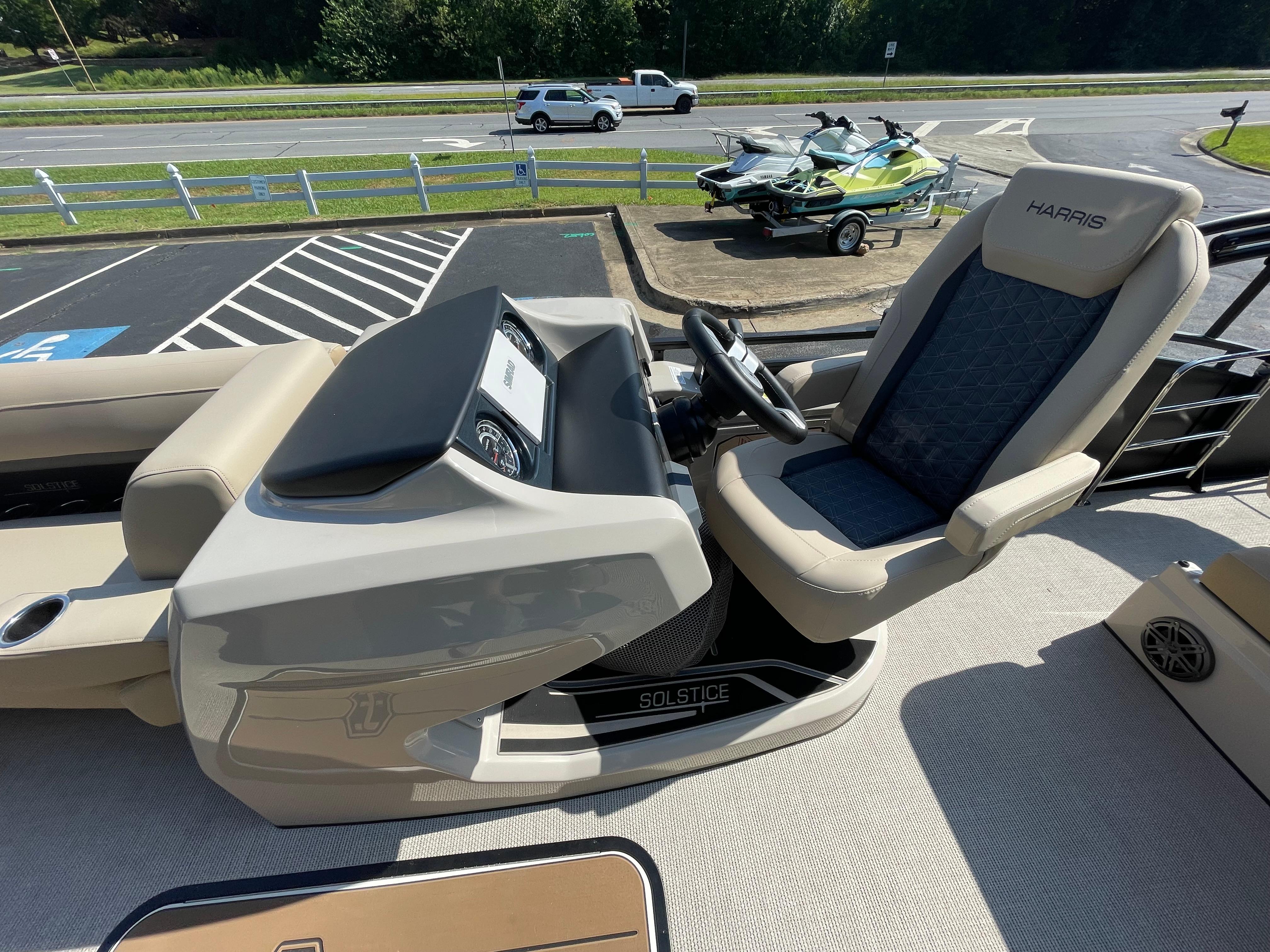 2026 Harris Solstice 230 boat interior with steering console and captain's chair.