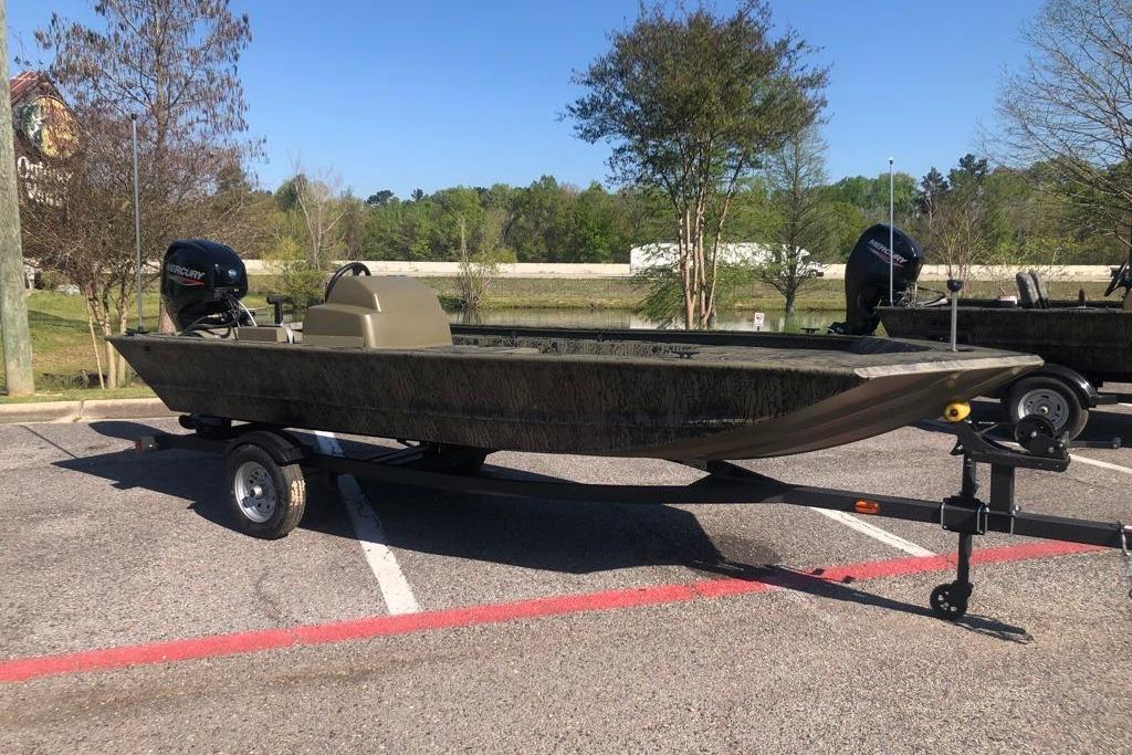 2026 Tracker Grizzly 1648 SC boat on trailer in parking lot.