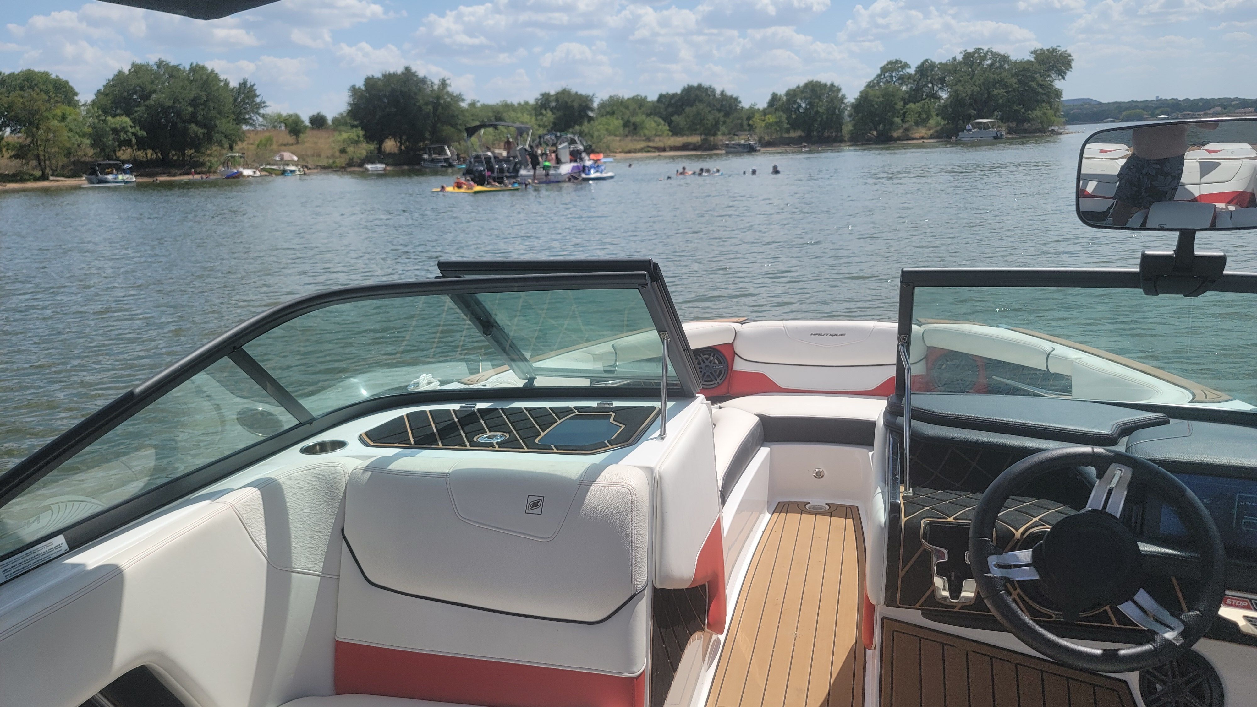 The image shows the cockpit of a 2019 Nautique Super Air Nautique GS22 on a lake.