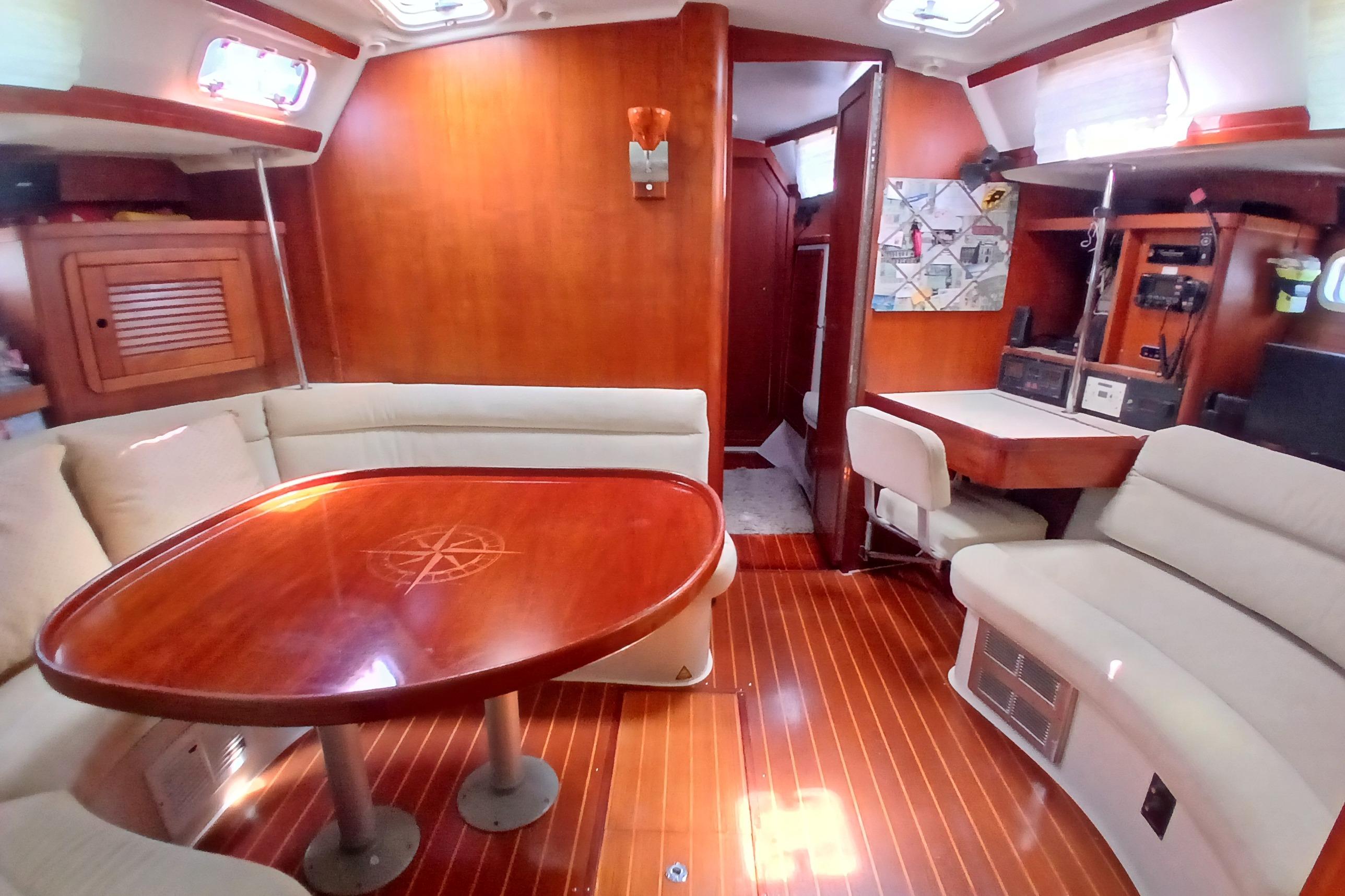Interior of a 1995 Catalina 42 MkII sailboat with wood finishes and seating area.
