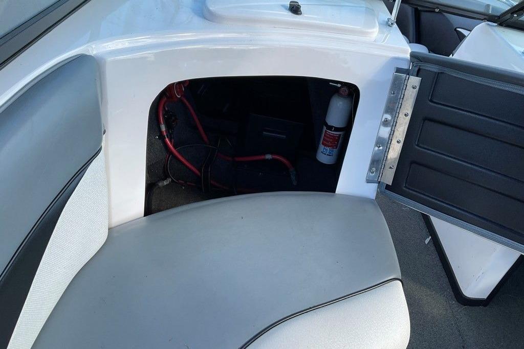 2015 Moomba Outback V boat interior storage compartment with fire extinguisher and wiring.