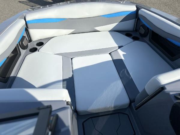 2025 Axis A225 boat interior with gray and blue cushioned seating.