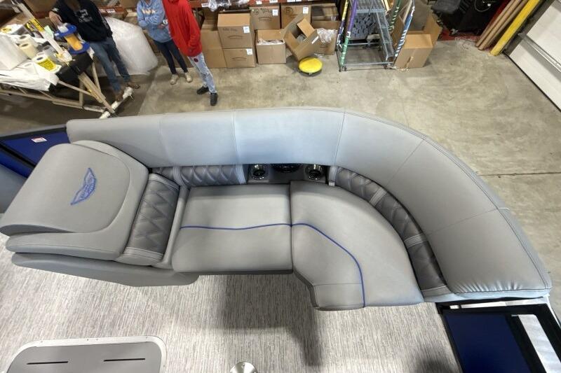 Luxurious seating on 2026 Bennington 23 LXS Swingback pontoon boat in a workshop setting.