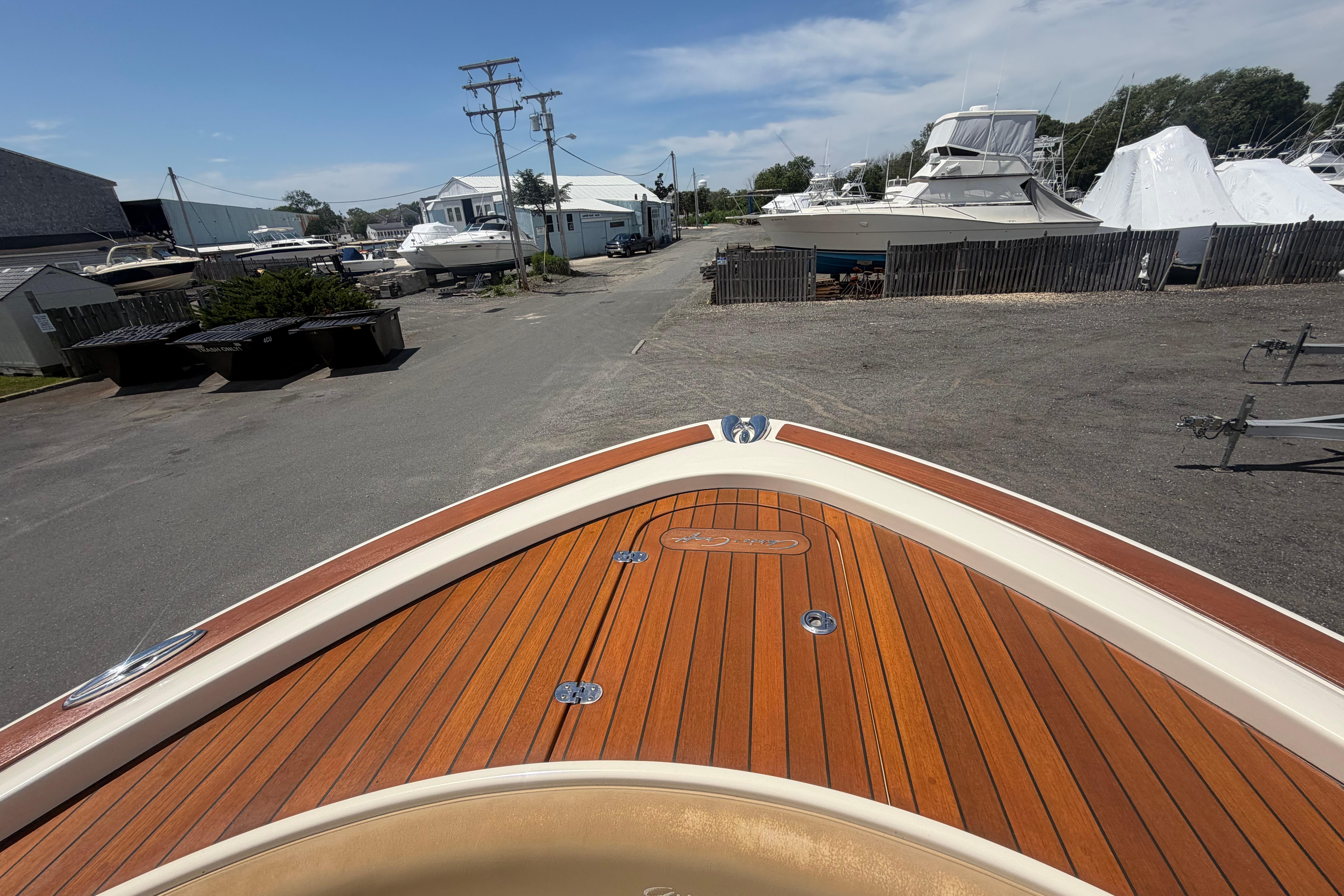 2017 Chris-Craft Catalina 34 boat with wooden deck at a marina.