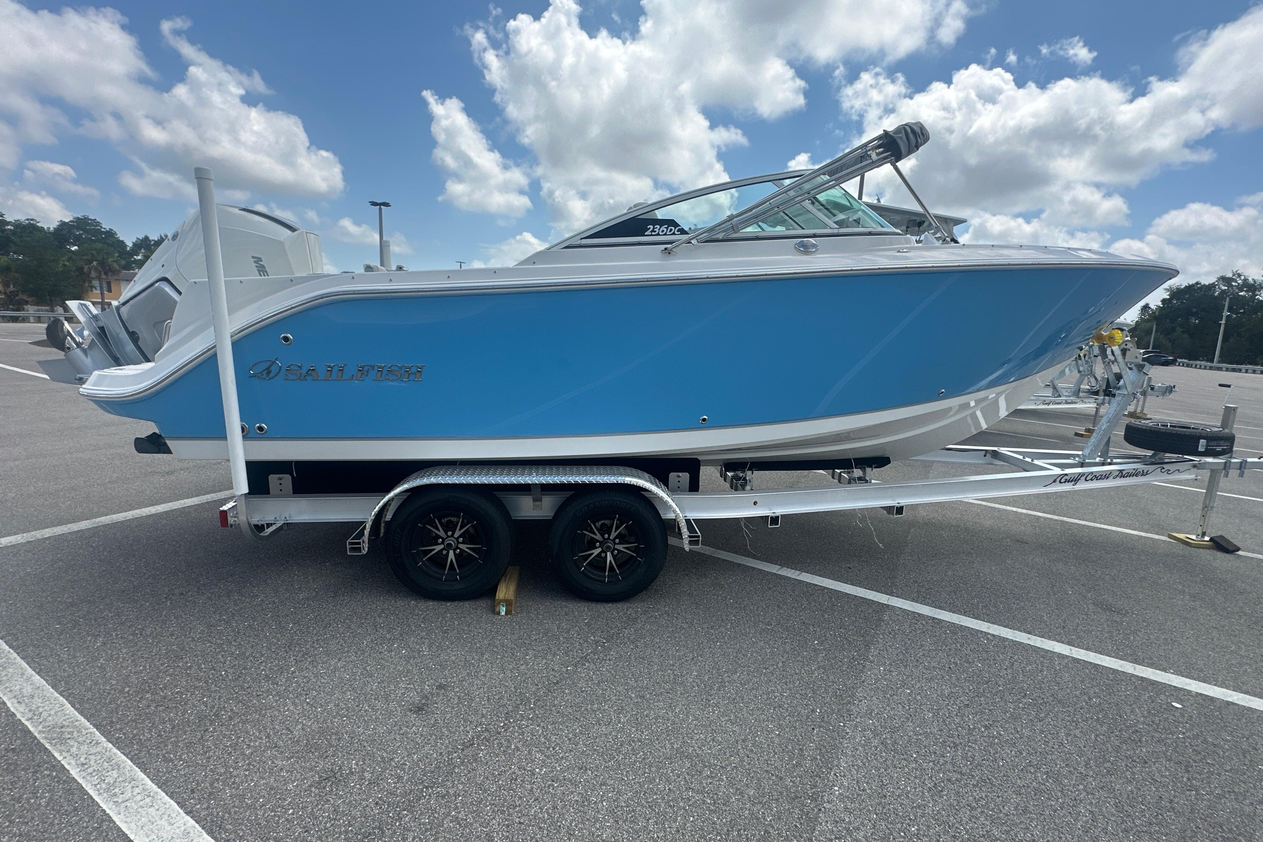 2026 Sailfish 226 DC boat on trailer under cloudy sky.