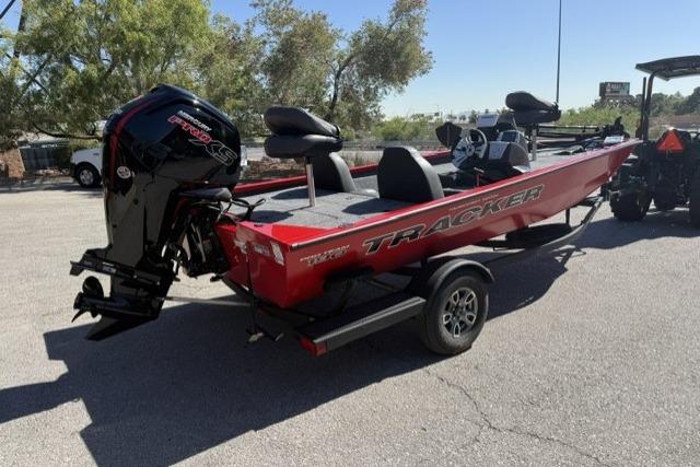 2026 Tracker Pro Team 190 boat, red, parked on trailer, outdoor setting.
