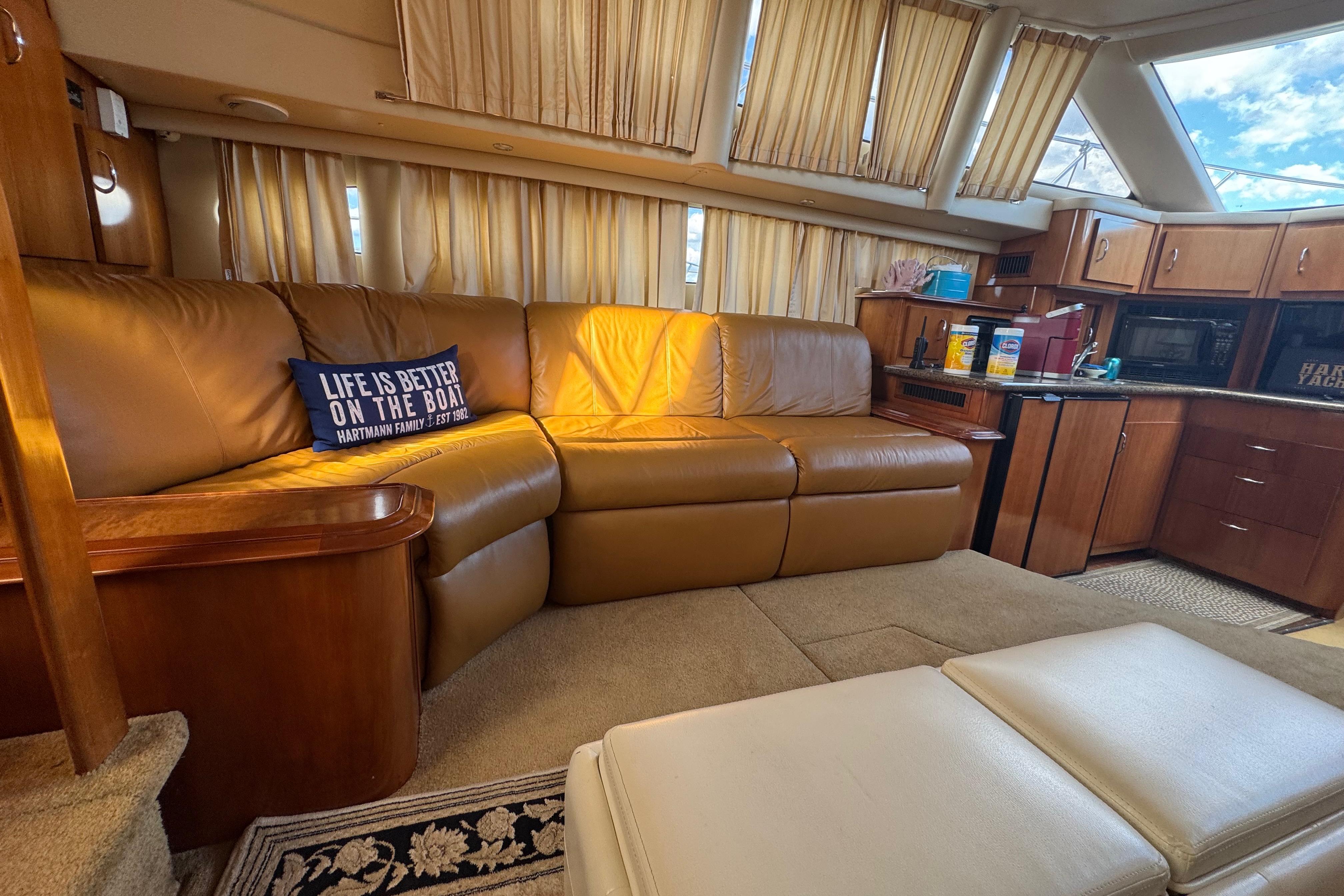 Luxurious interior of 2003 Carver 444 Cockpit Motor Yacht with leather seating and kitchenette.