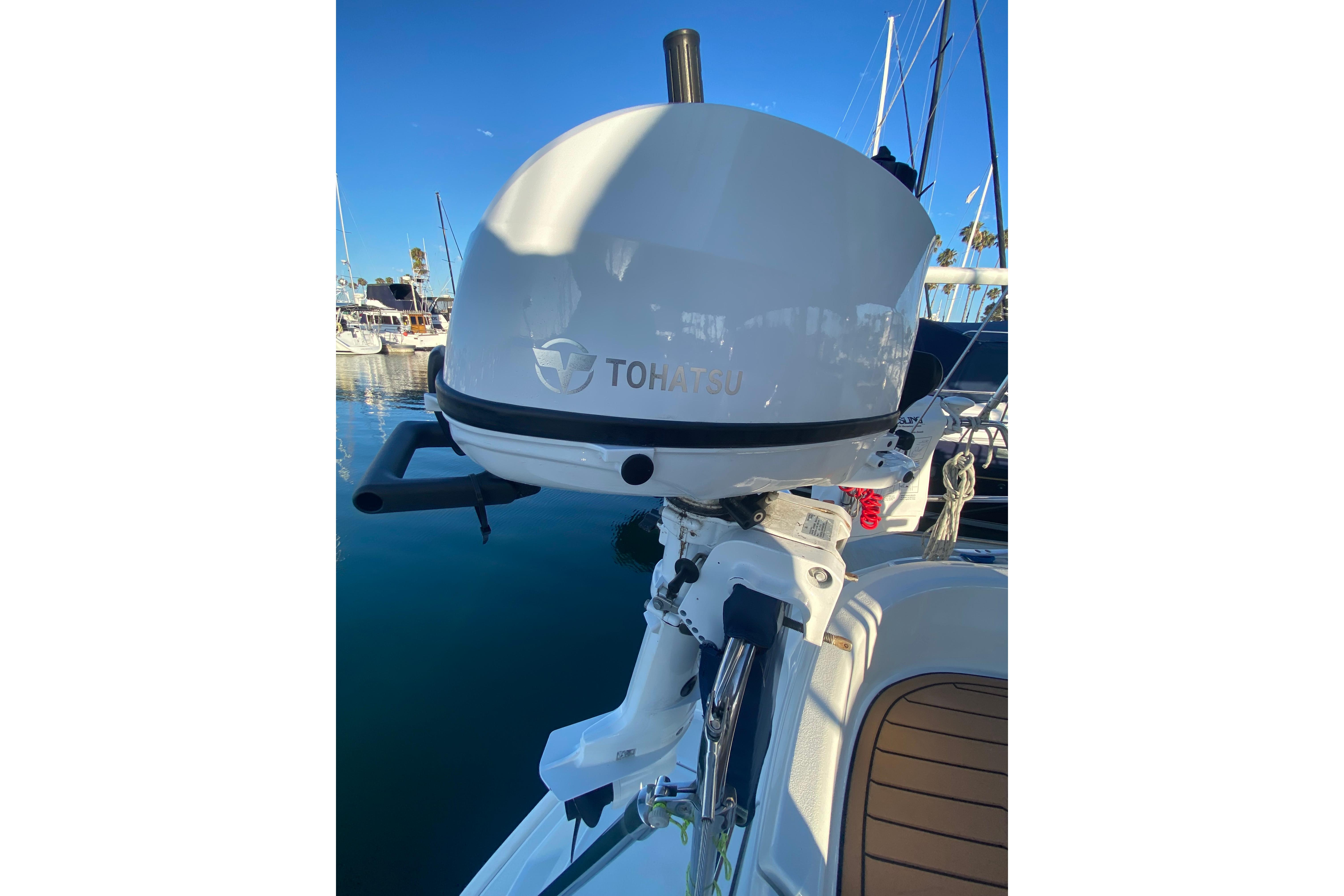 Outboard motor on a 1997 Hunter Legend 40.5 sailboat, docked in a marina.